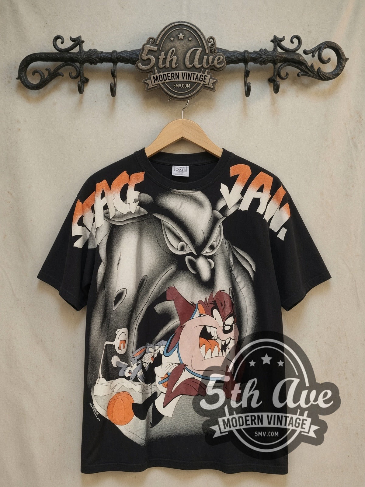 Looney Tunes Space Jam all-over-print vintage cartoon tee, front view on a display rack