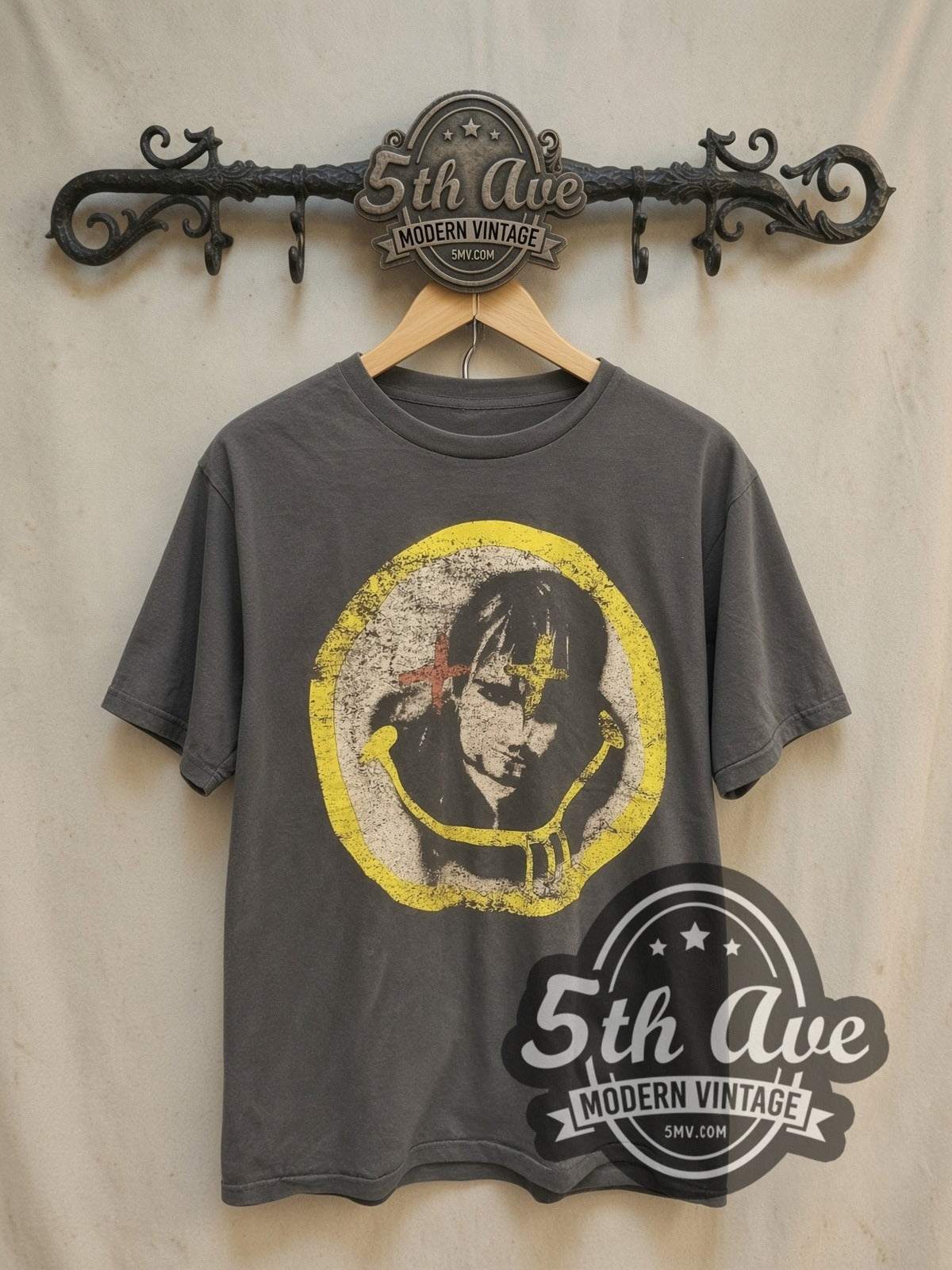 Nirvana Kurt Cobain Cross-Eyes Yellow Circle Portrait vintage band t-shirt, front view on a display rack