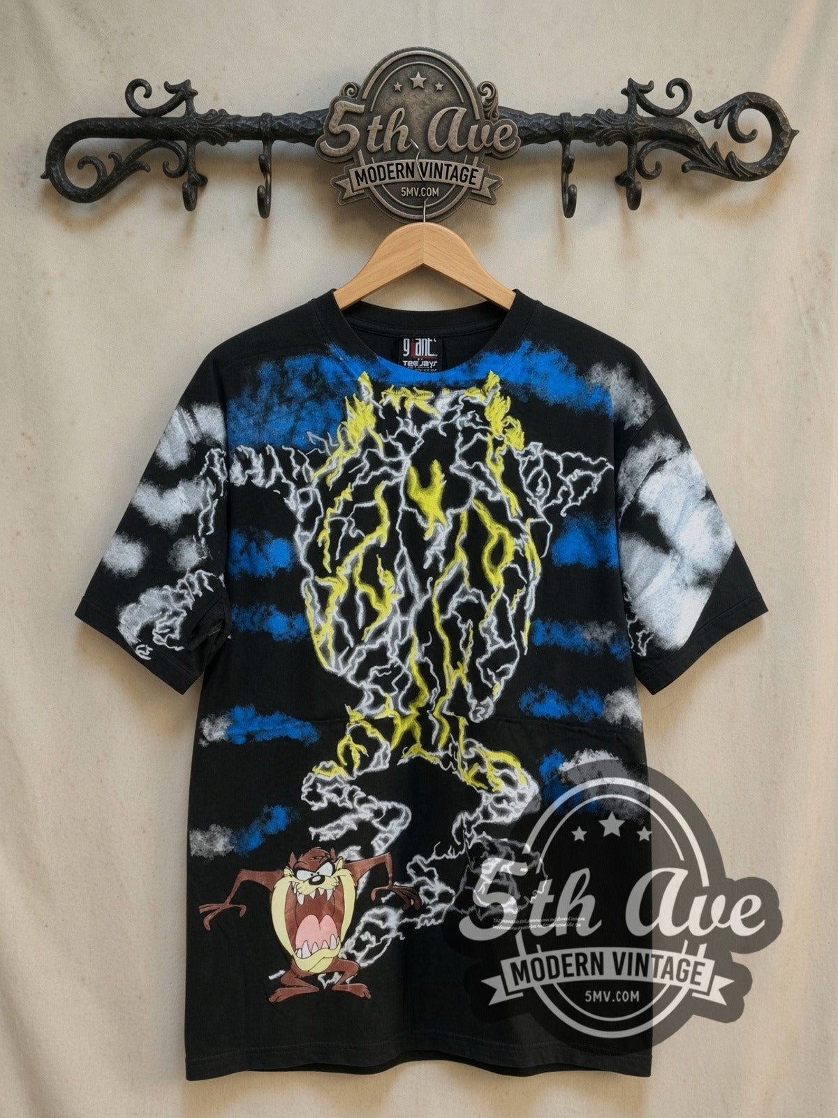 Looney Tunes Taz-Mania Iconic Design all-over-print vintage cartoon tee, front view on a display rack