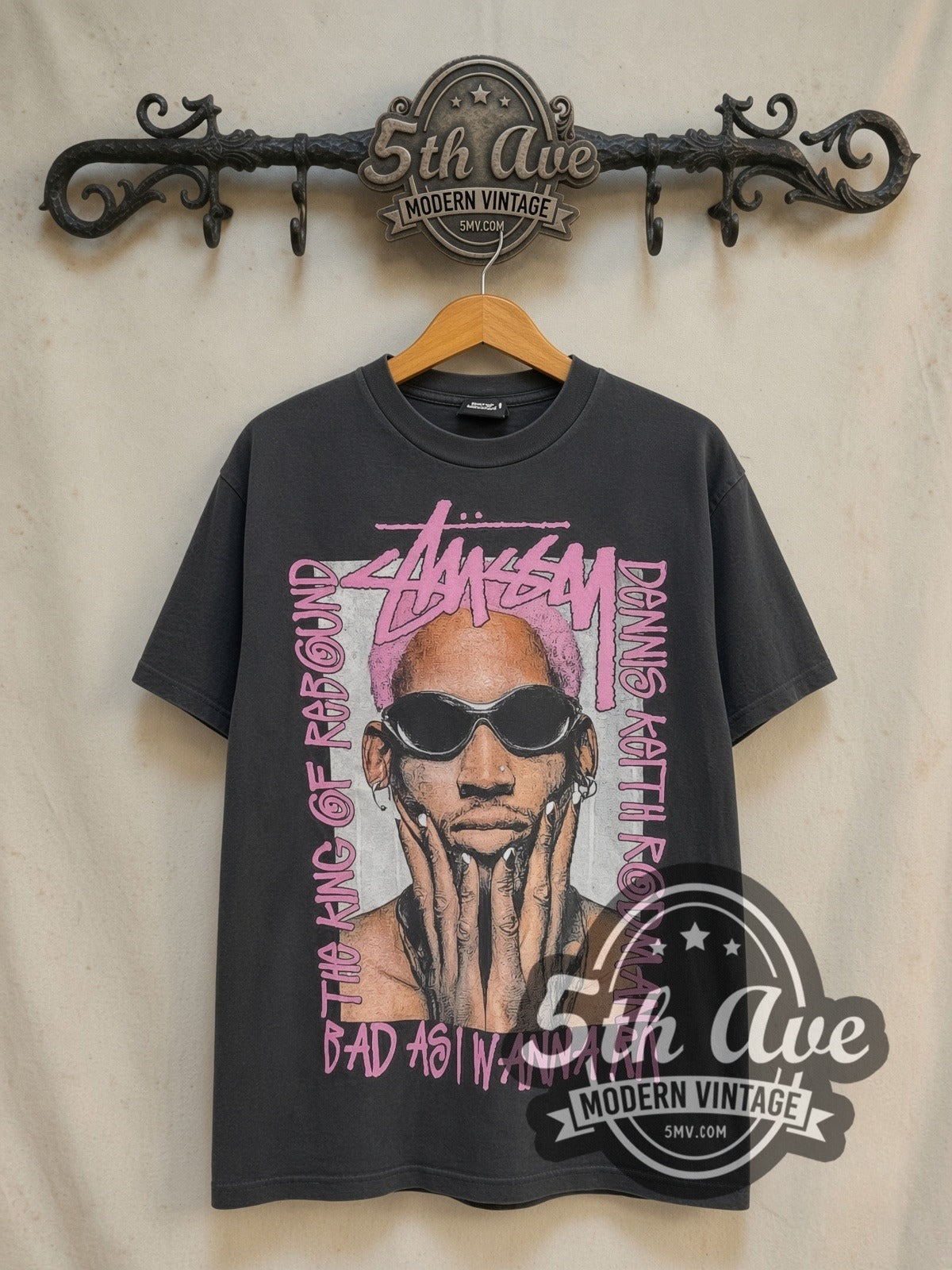 Dennis Rodman x Stüssy The King of Rebound vintage basketball tee in black, front view on a display rack