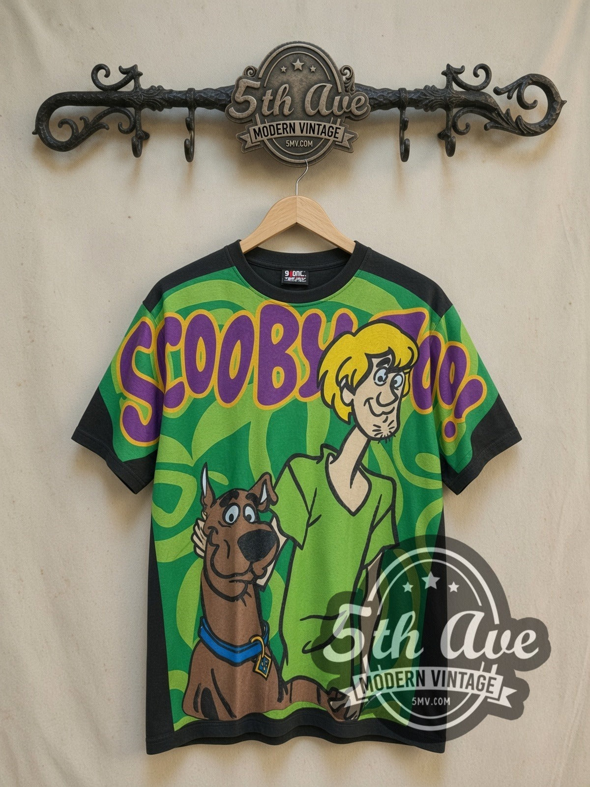 Scooby-Doo all-over-print vintage cartoon tee, front view on a display rack