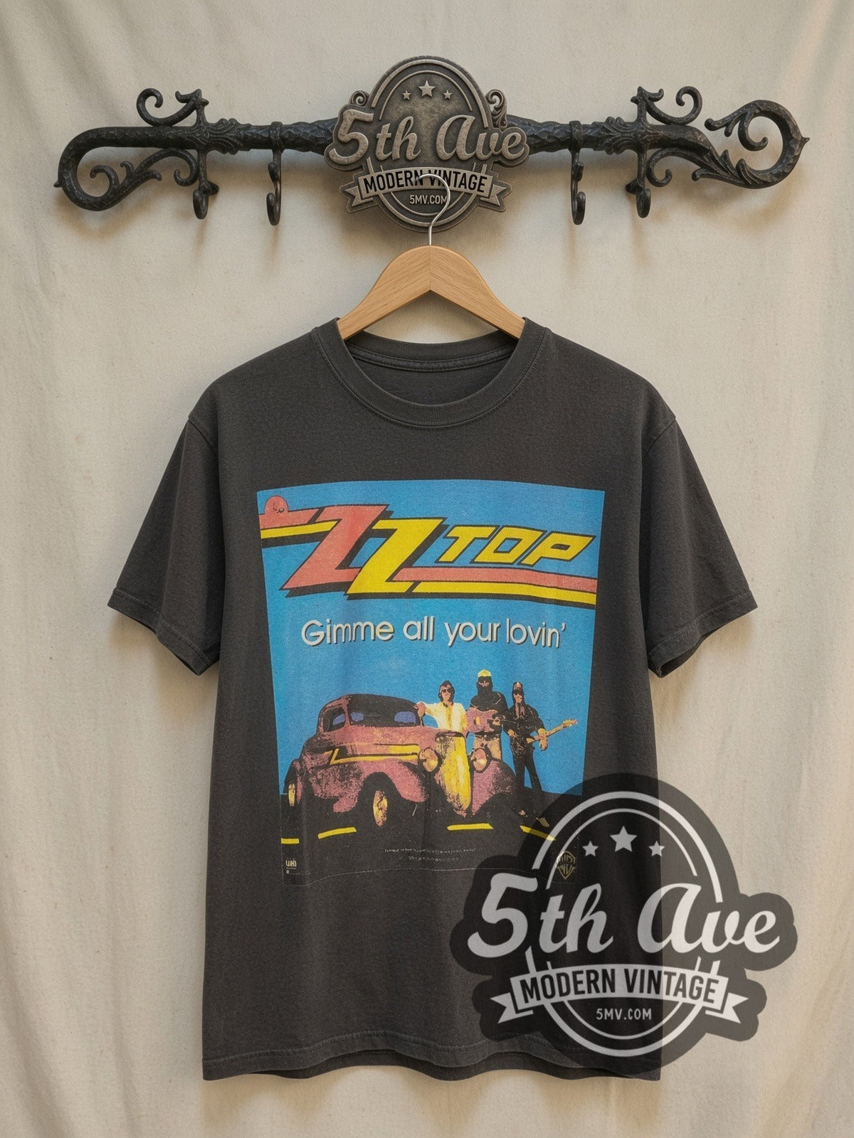 ZZ Top Gimme All Your Lovin' vintage band t-shirt, front view on a display rack