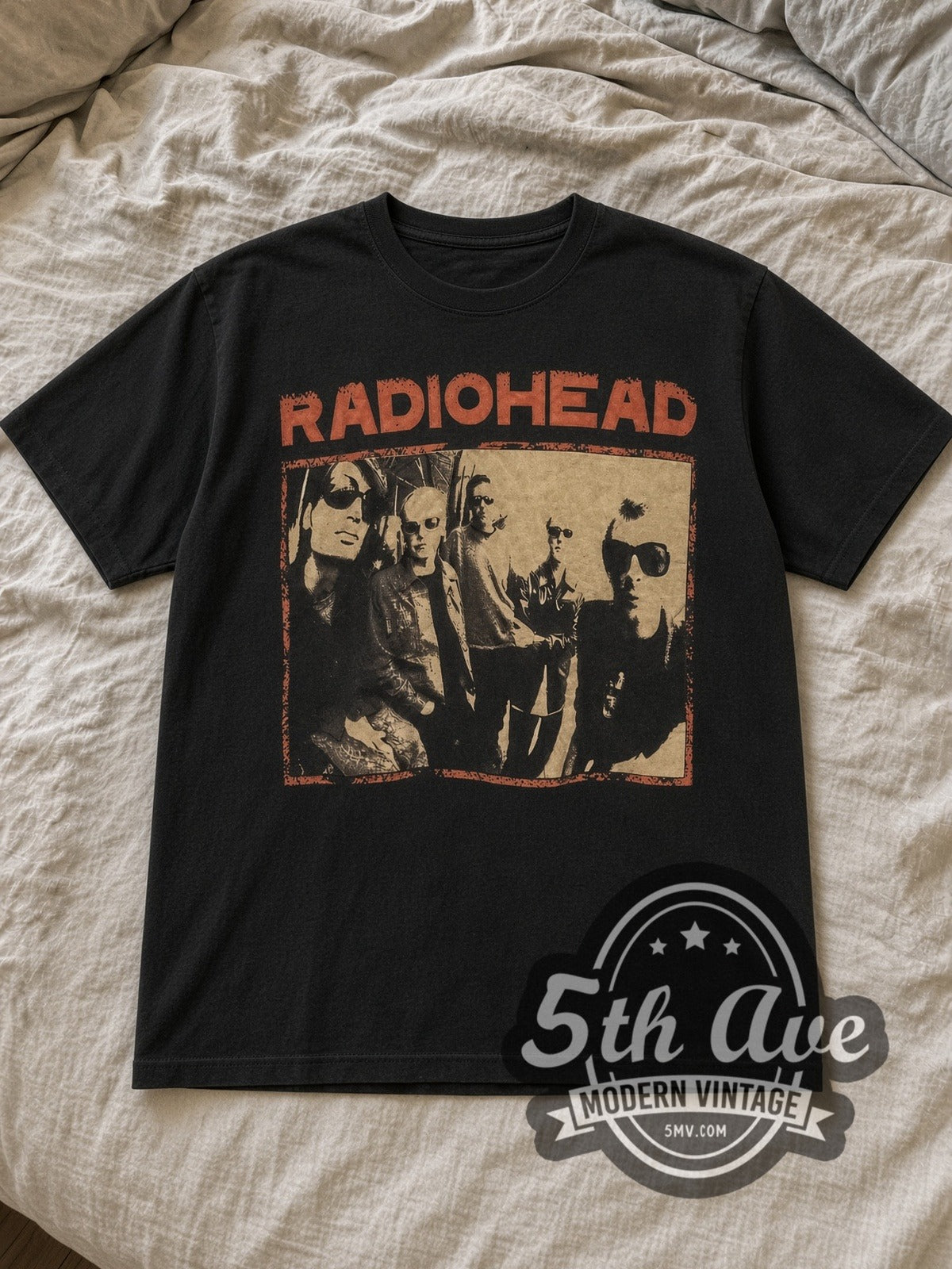 Black Radiohead Black Vintage Band T-Shirt laid flat on a linen bed