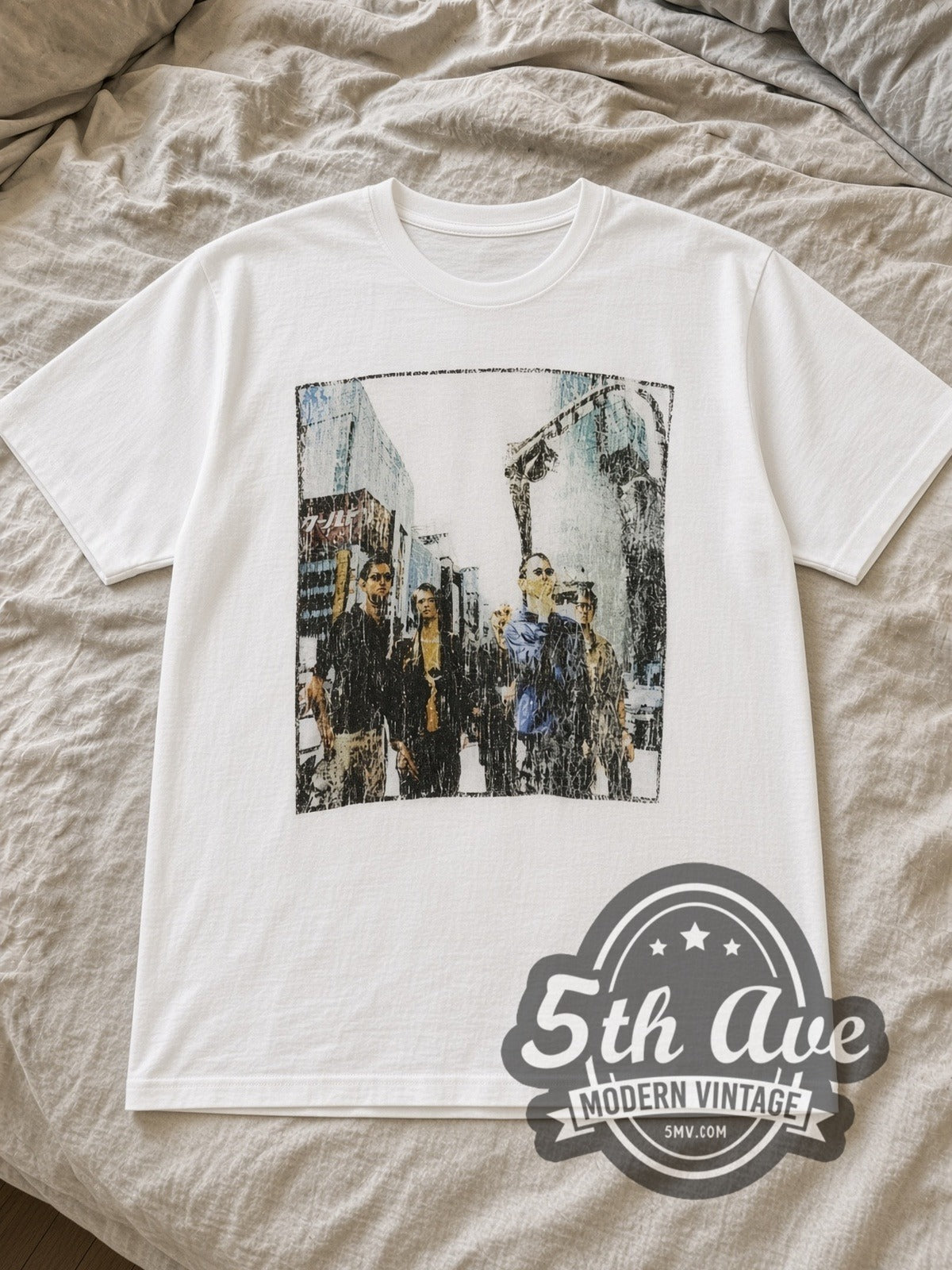 White Radiohead Tokyo Street Walking Photo White Vintage Band T-Shirt laid flat on a linen bed