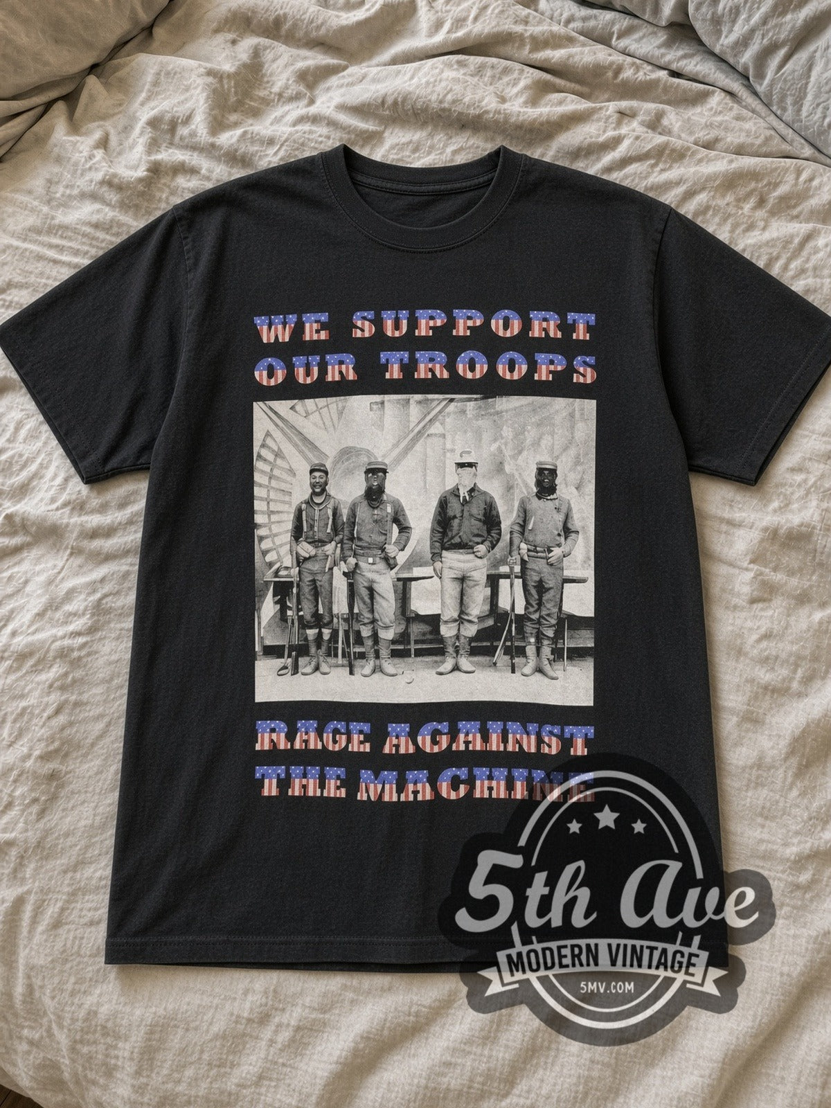 Black Rage Against the Machine We Support Our Troops' North American Tour 1997 Vintage Band T-Shirt laid flat on a linen bed