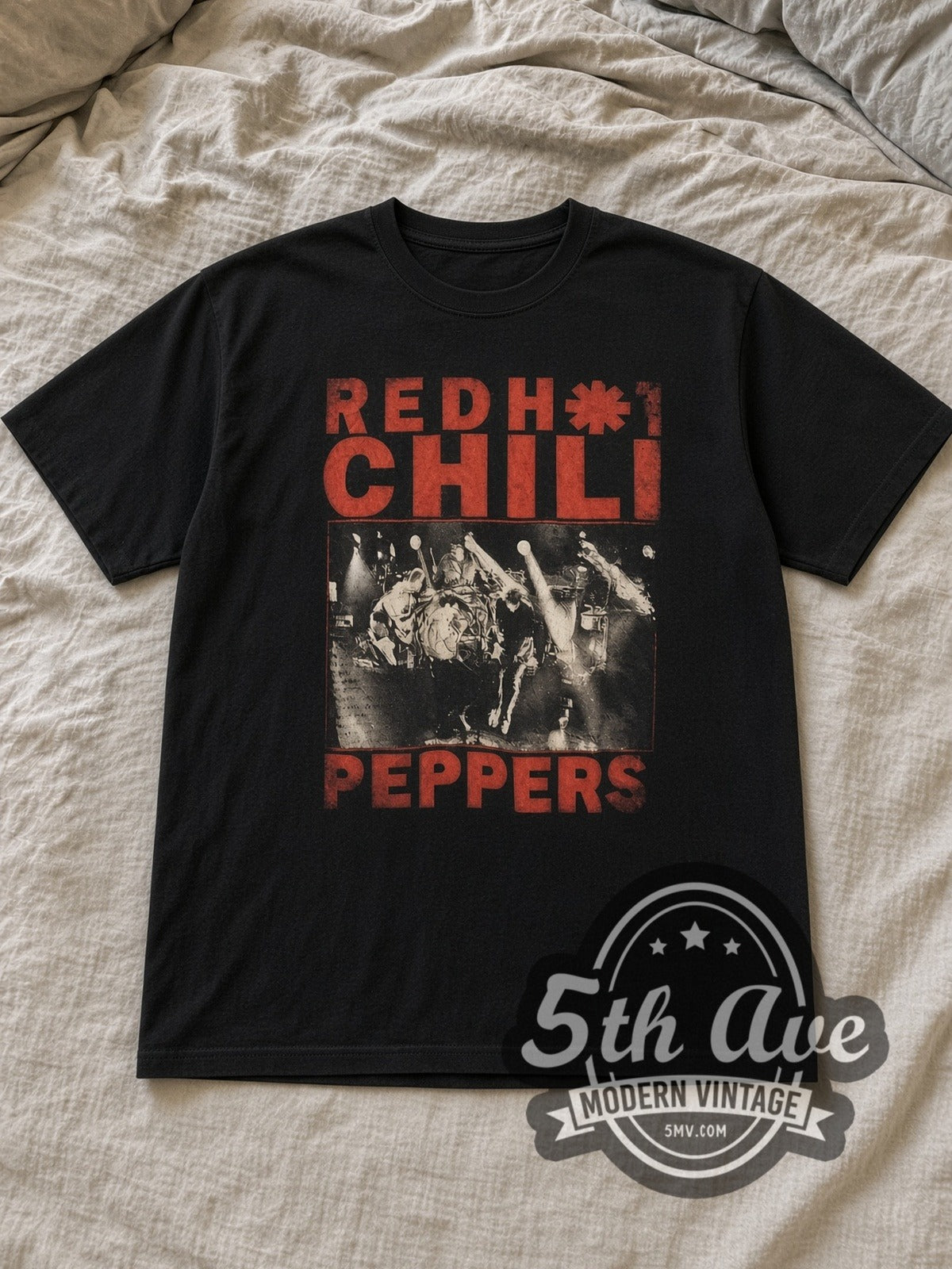 Black Red Hot Chili Peppers Distressed Red Text Live Stage Shot Vintage Band T-Shirt laid flat on a linen bed