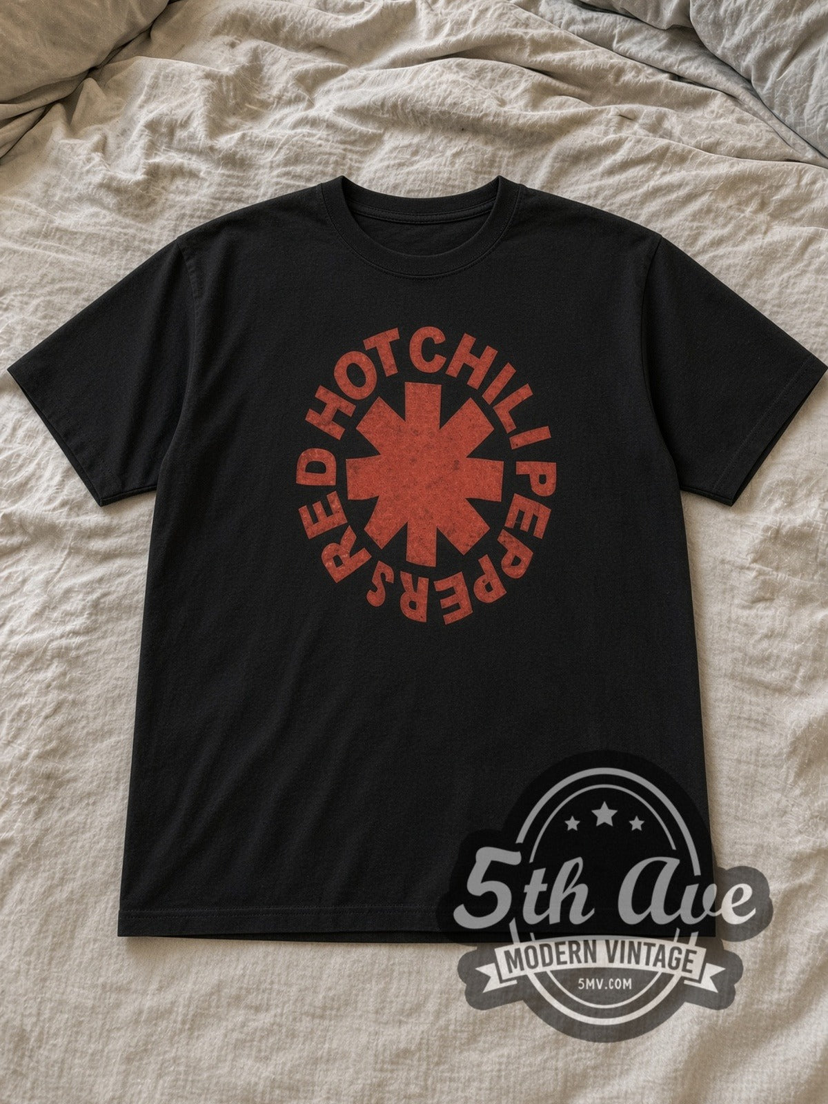 Black Red Hot Chili Peppers Classic Red Asterisk Circle Logo Vintage Band T-Shirt laid flat on a linen bed