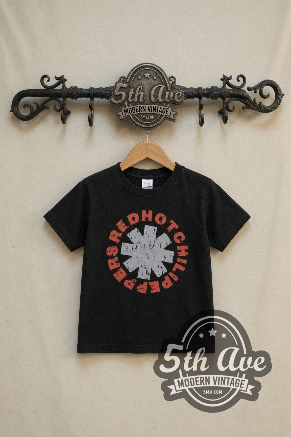 Red Hot Chili Peppers Asterisk Circle kids band tee in black, front view on a display rack