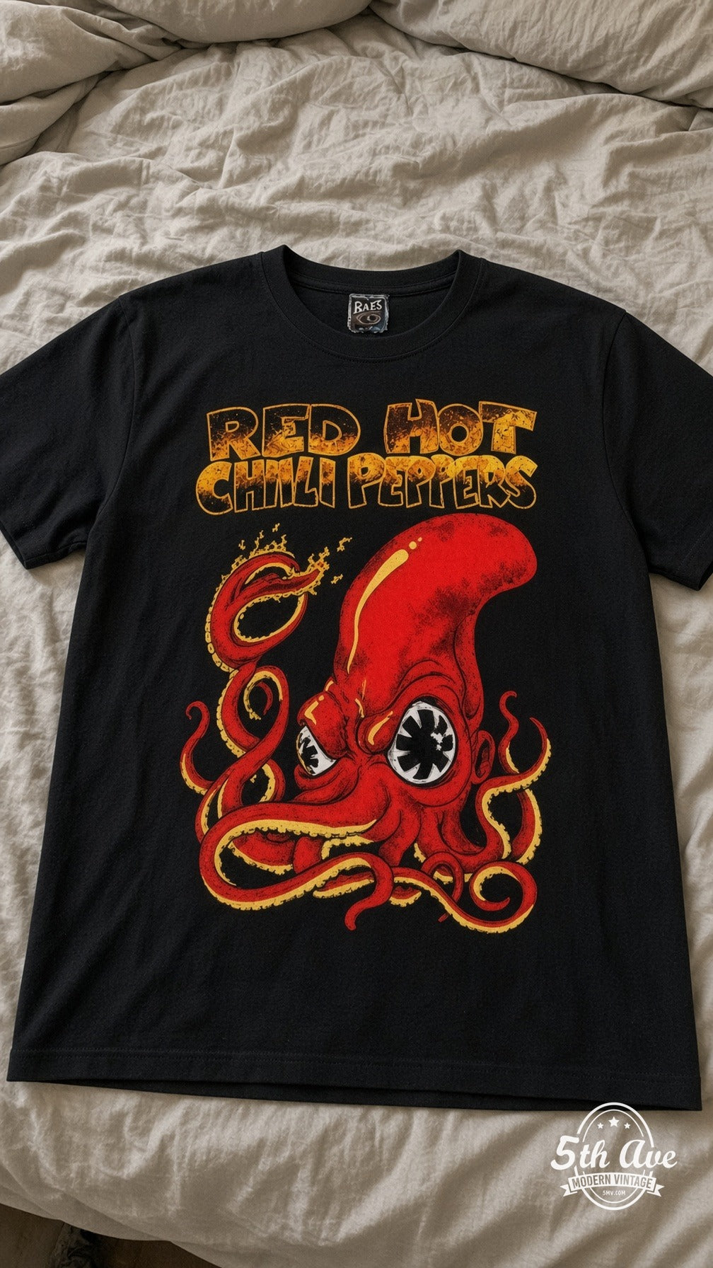 Red Hot Chili Peppers octopus vintage t-shirt laid on bed
