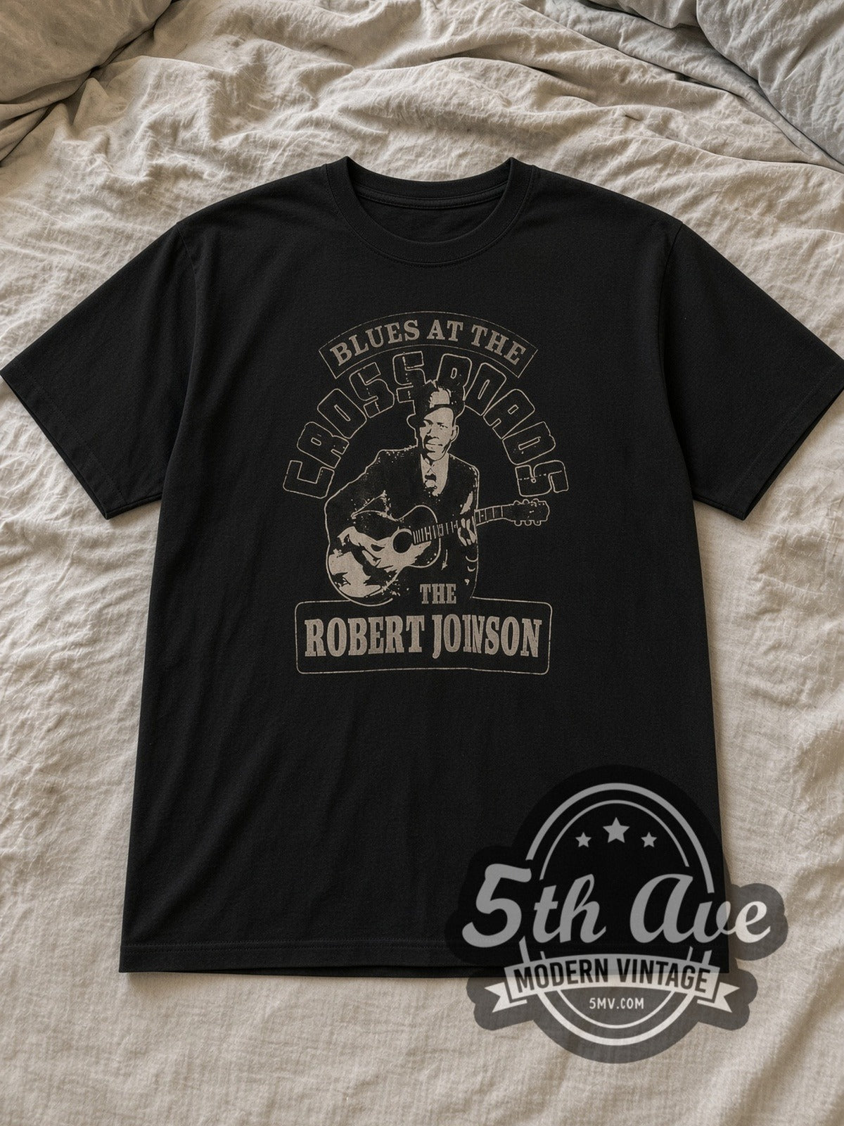 Black Robert Johnson Vintage Band T-Shirt laid flat on a linen bed