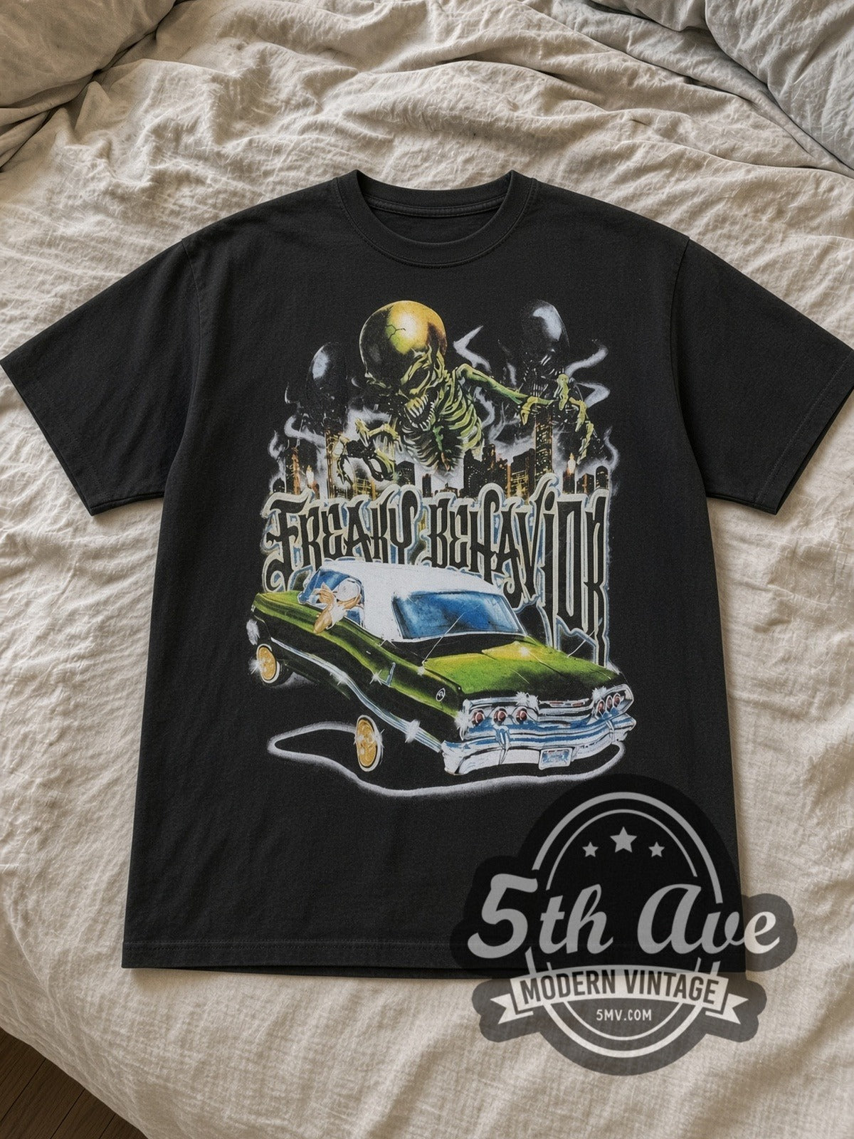 Black Rollin Hard Freaky Behavior Lowrider Vintage Graphic T-Shirt laid flat on a linen bed