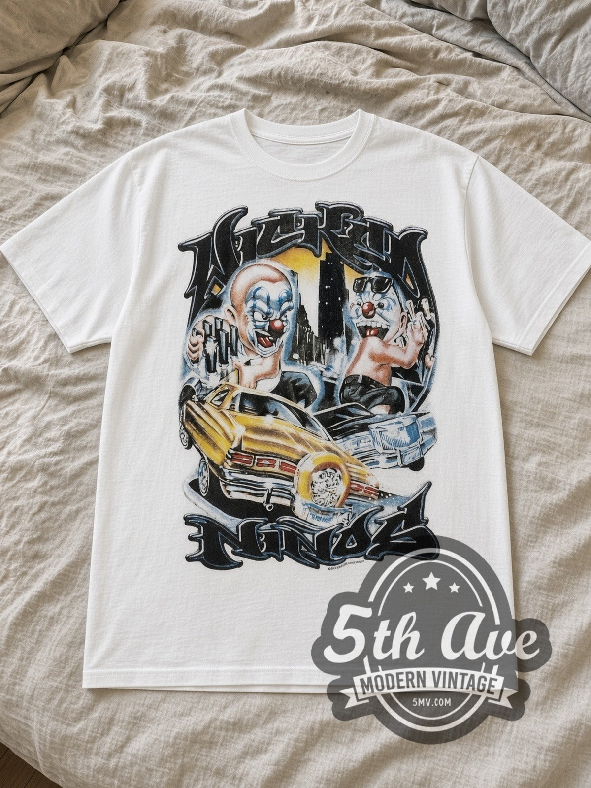 White Rollin Hard Lowrider Clowns Unleashed Vintage Graphic T-Shirt laid flat on a linen bed