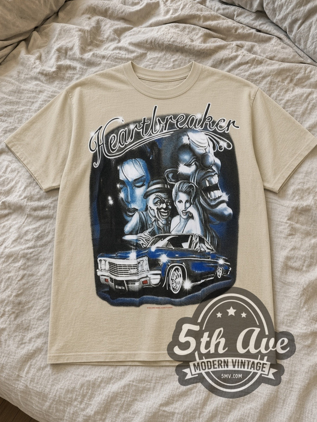 Sand Rollin Hard Heartbreaker Lowrider Vintage Graphic T-Shirt laid flat on a linen bed
