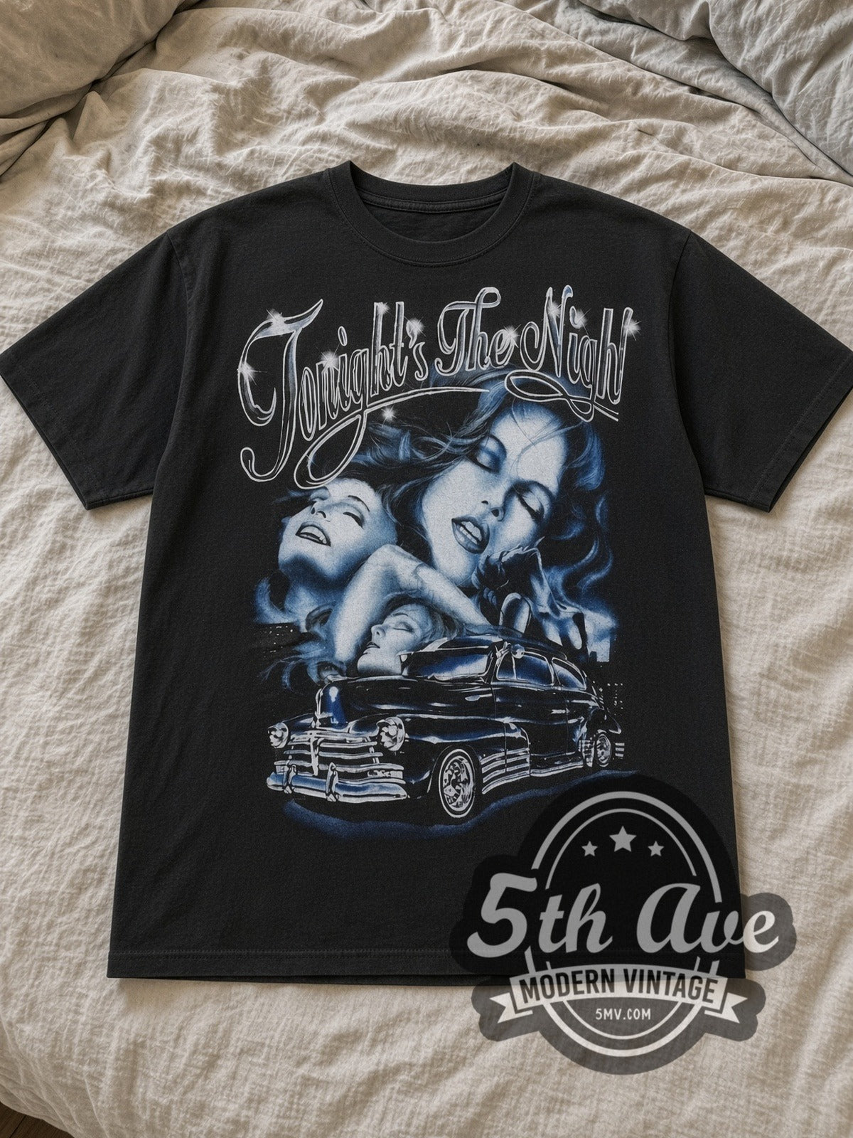Black Rollin Hard Tonight's the Night Lowrider Vintage Graphic T-Shirt laid flat on a linen bed