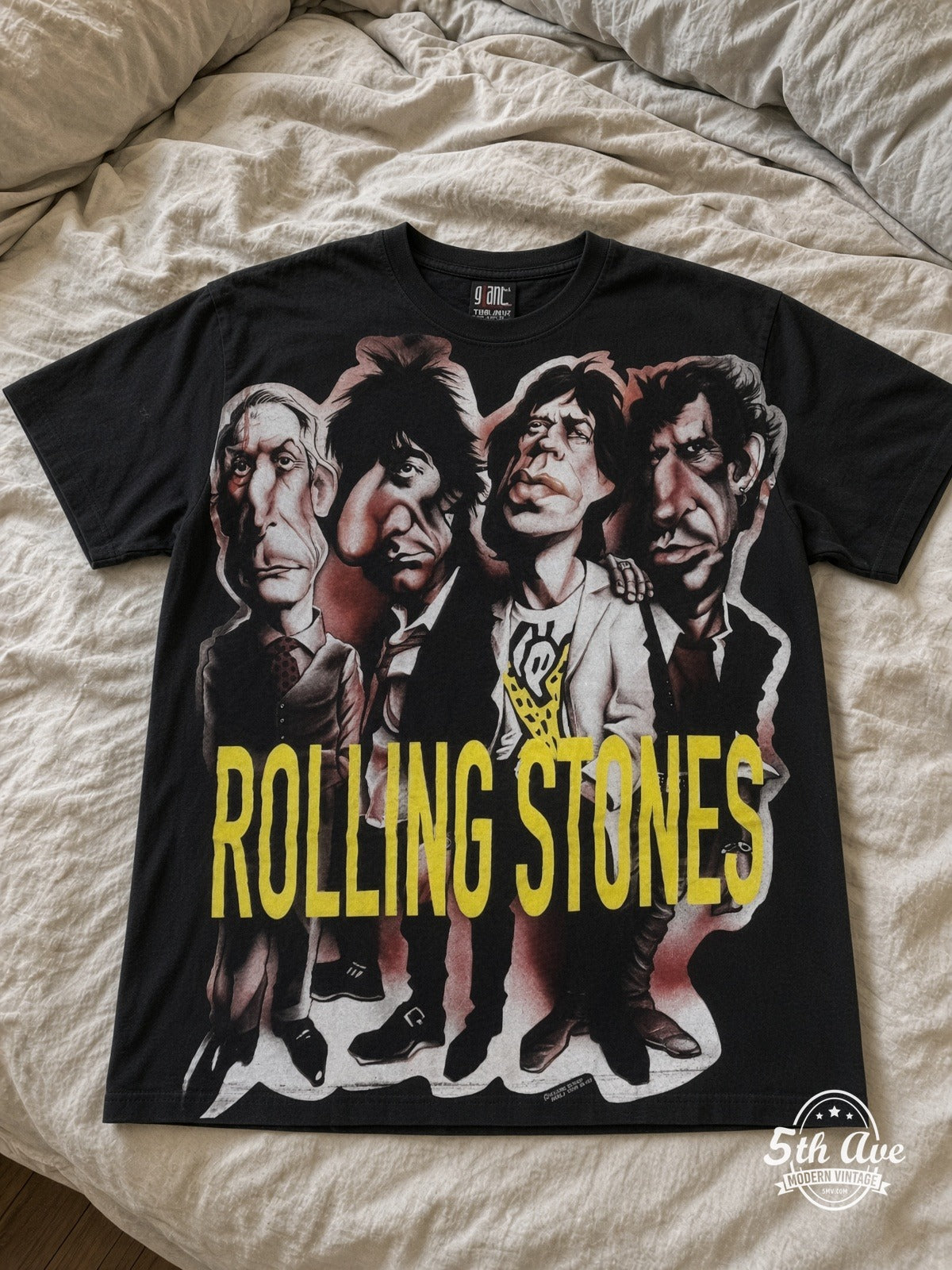 The Rolling Stones Voodoo Lounge Caricature Black all over print vintage tee laid on bed
