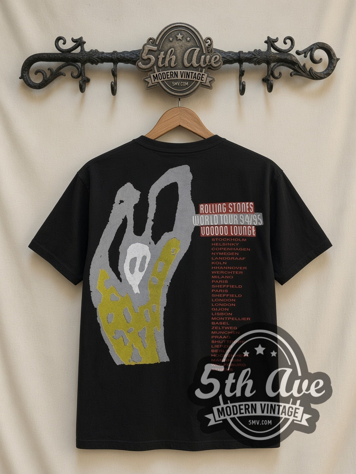 The Rolling Stones Voodoo Lounge Caricature all-over-print vintage band t-shirt in black, back view on a display rack