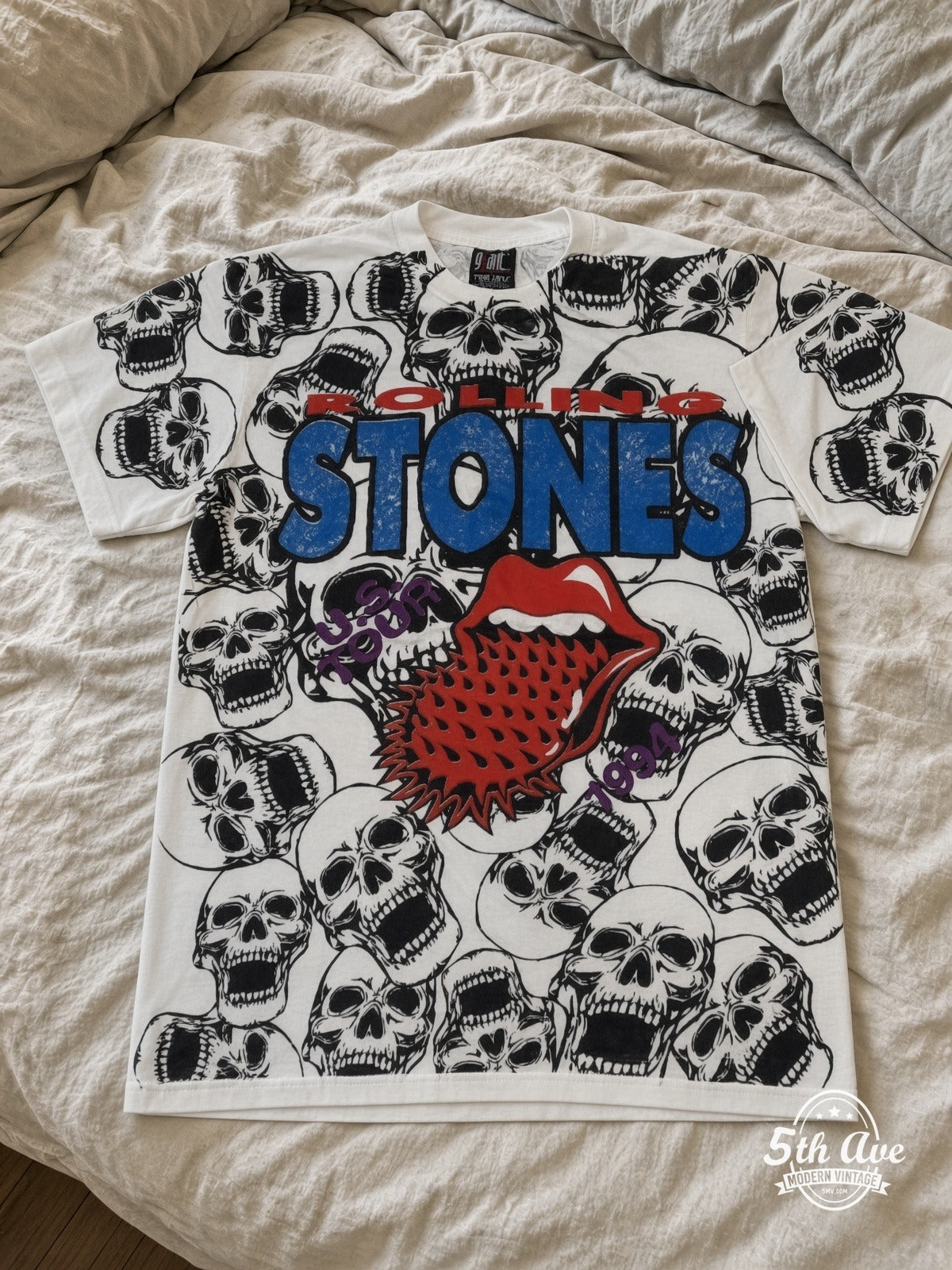 The Rolling Stones Voodoo Lounge Skulls all over print vintage tee laid on bed