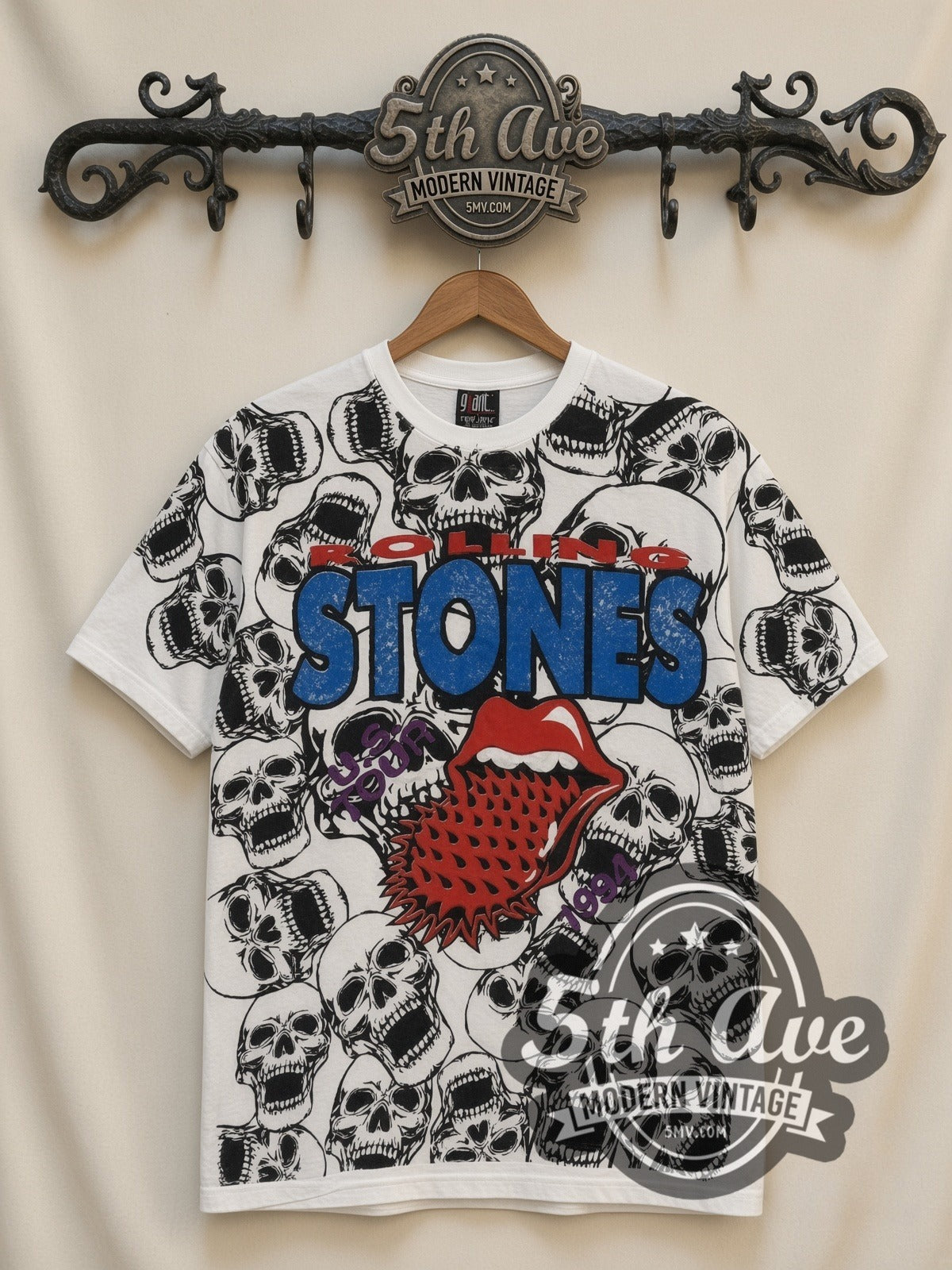 The Rolling Stones Voodoo Lounge Skulls all-over-print vintage band t-shirt in white, front view on a display rack