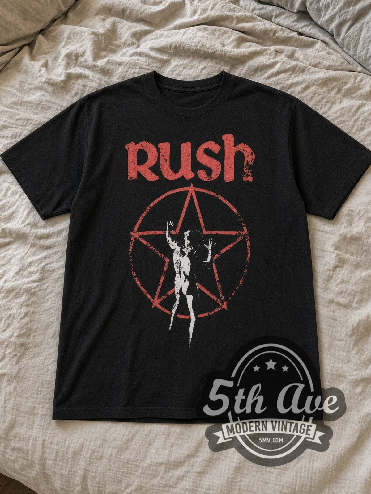 Black Rush Starman Vintage Band T-Shirt laid flat on a linen bed