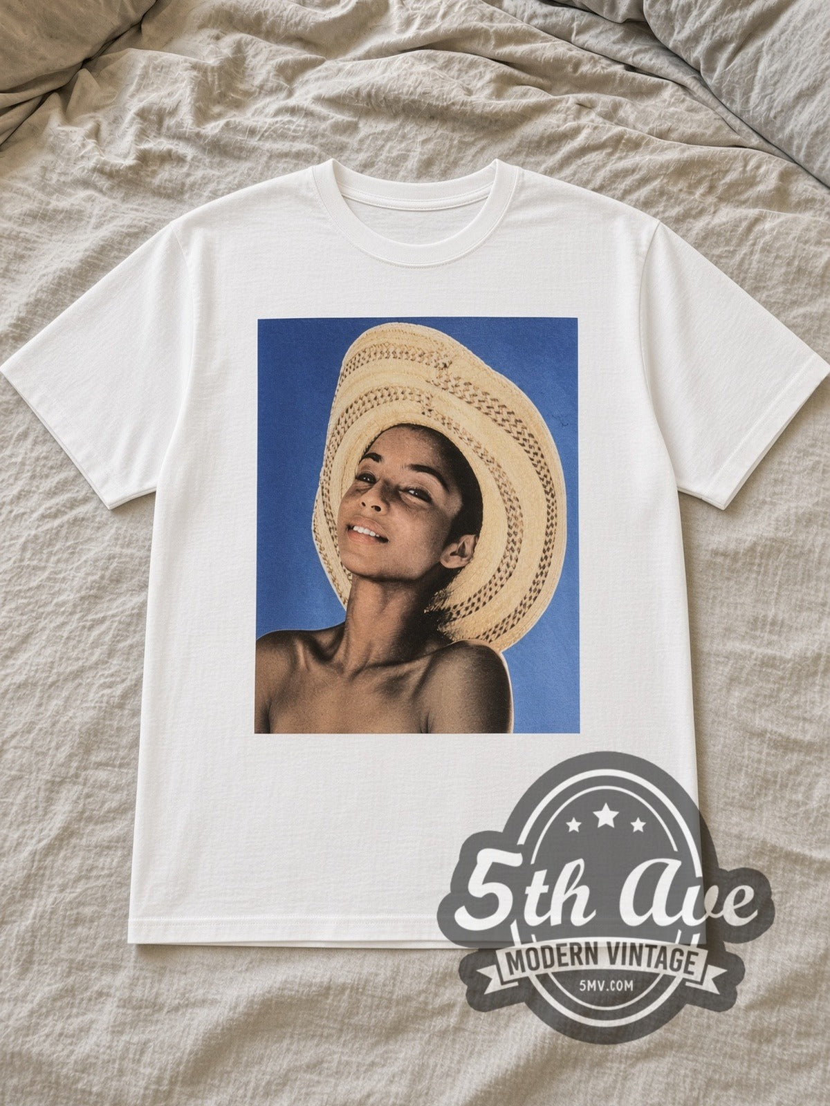 White Sade Stronger Than Pride straw hat tee laid flat on linen bed