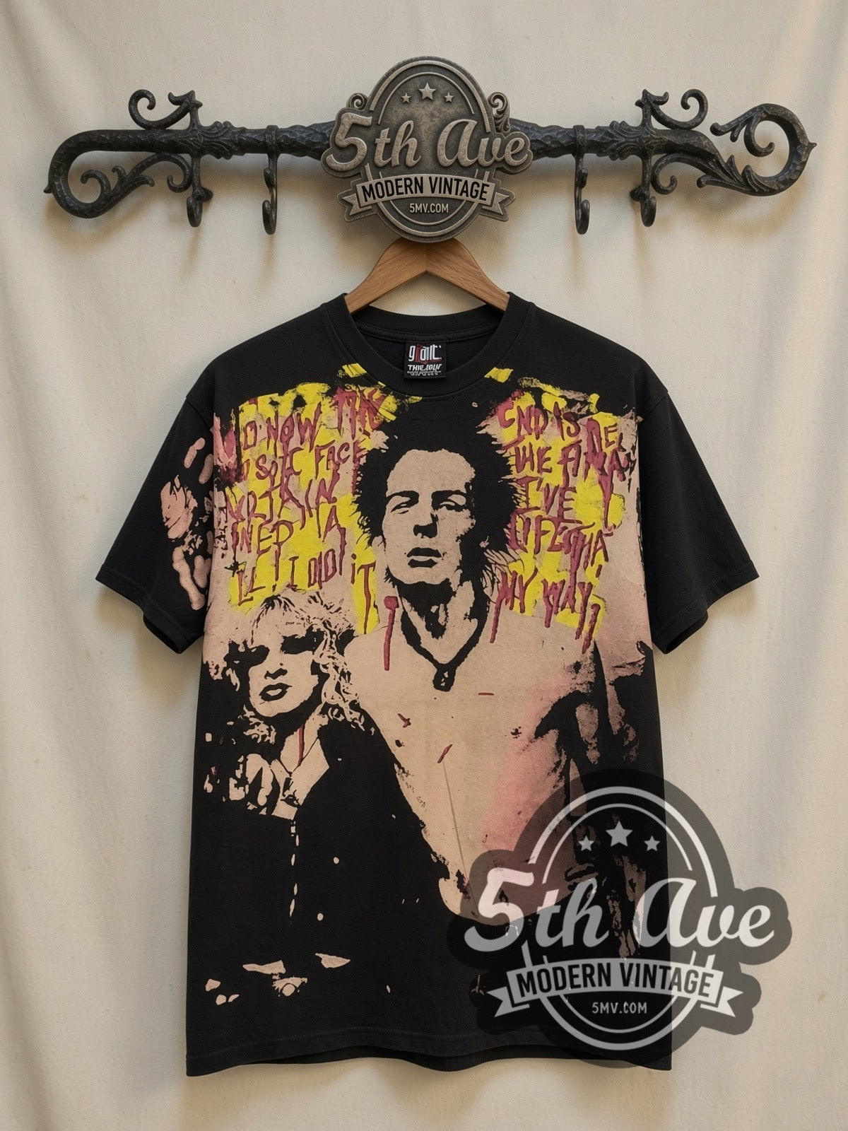 Sex Pistols Sid Vicious Nancy Spungen all-over-print vintage band t-shirt in black, front view on a display rack