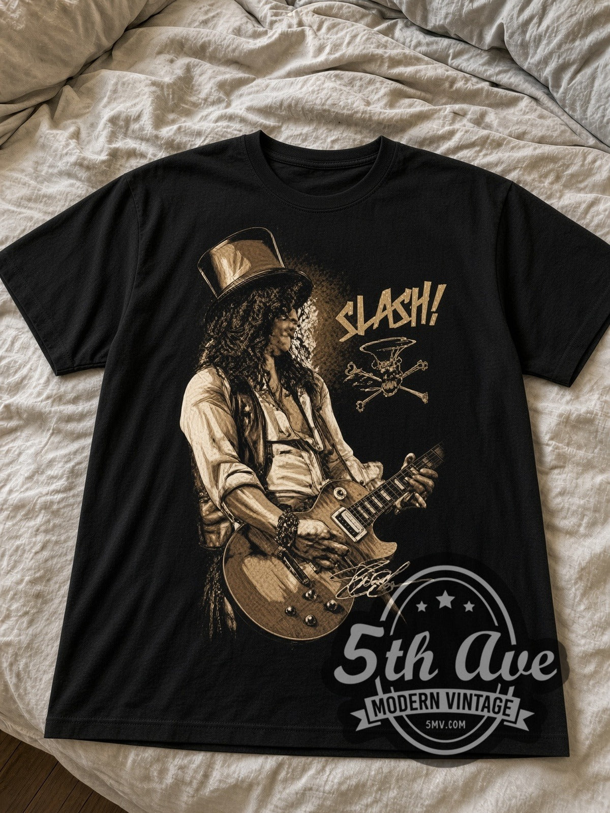 Slash Top Hat with Les Paul black graphic tee laid flat on linen bed