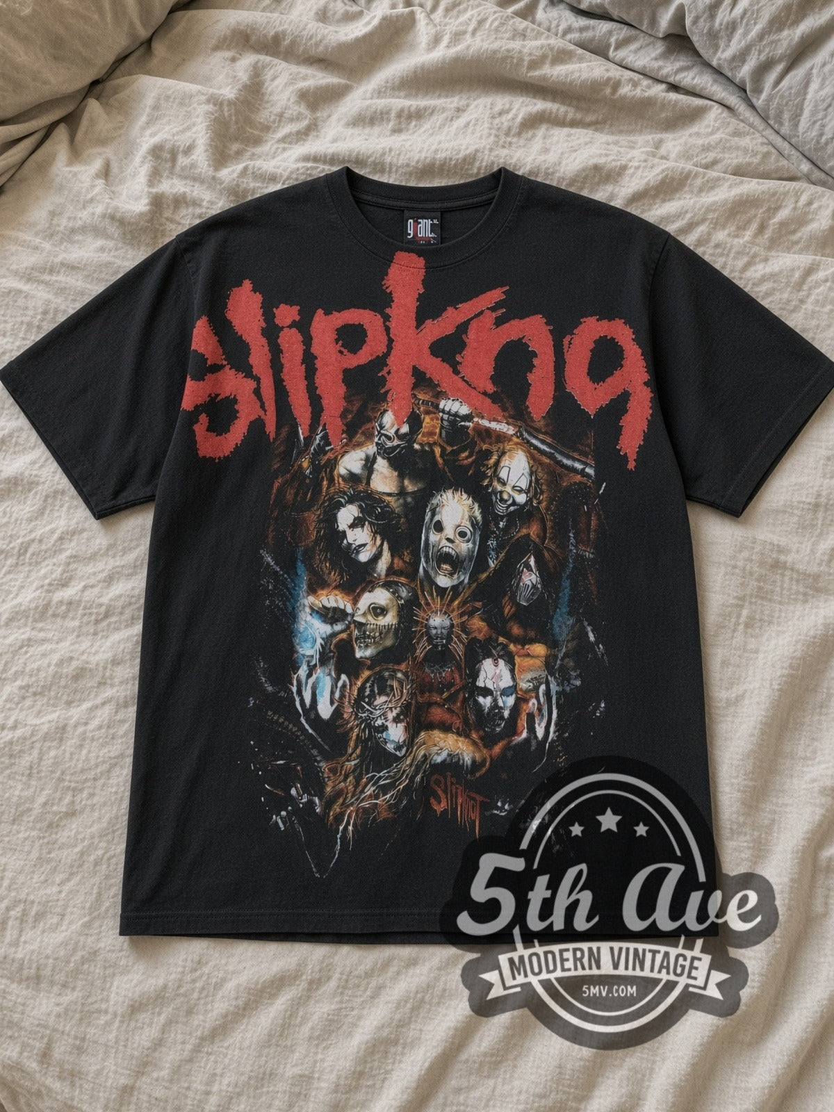 Black Slipknot Nine Mask Fiery Group Collage Vintage Band T-Shirt laid flat on a linen bed