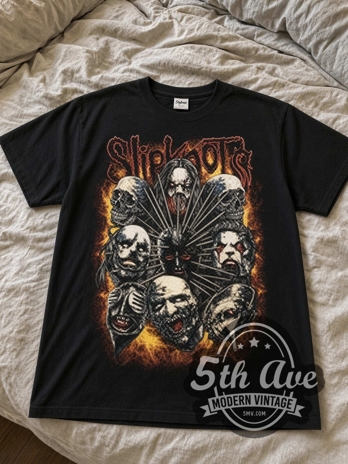 Slipknot Masks Cluster with Flames black graphic tee laid flat on linen bed