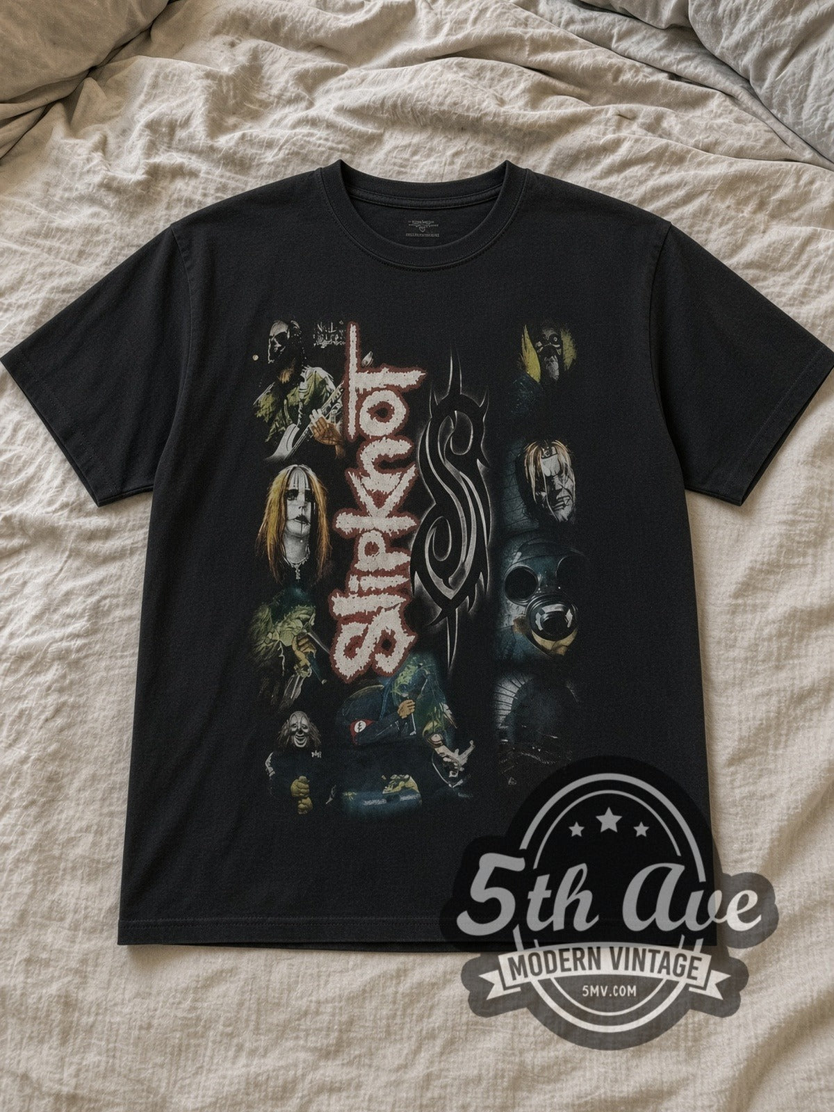 Black Slipknot Vertical Logo Tribal S Mask Collage Vintage Band T-Shirt laid flat on a linen bed