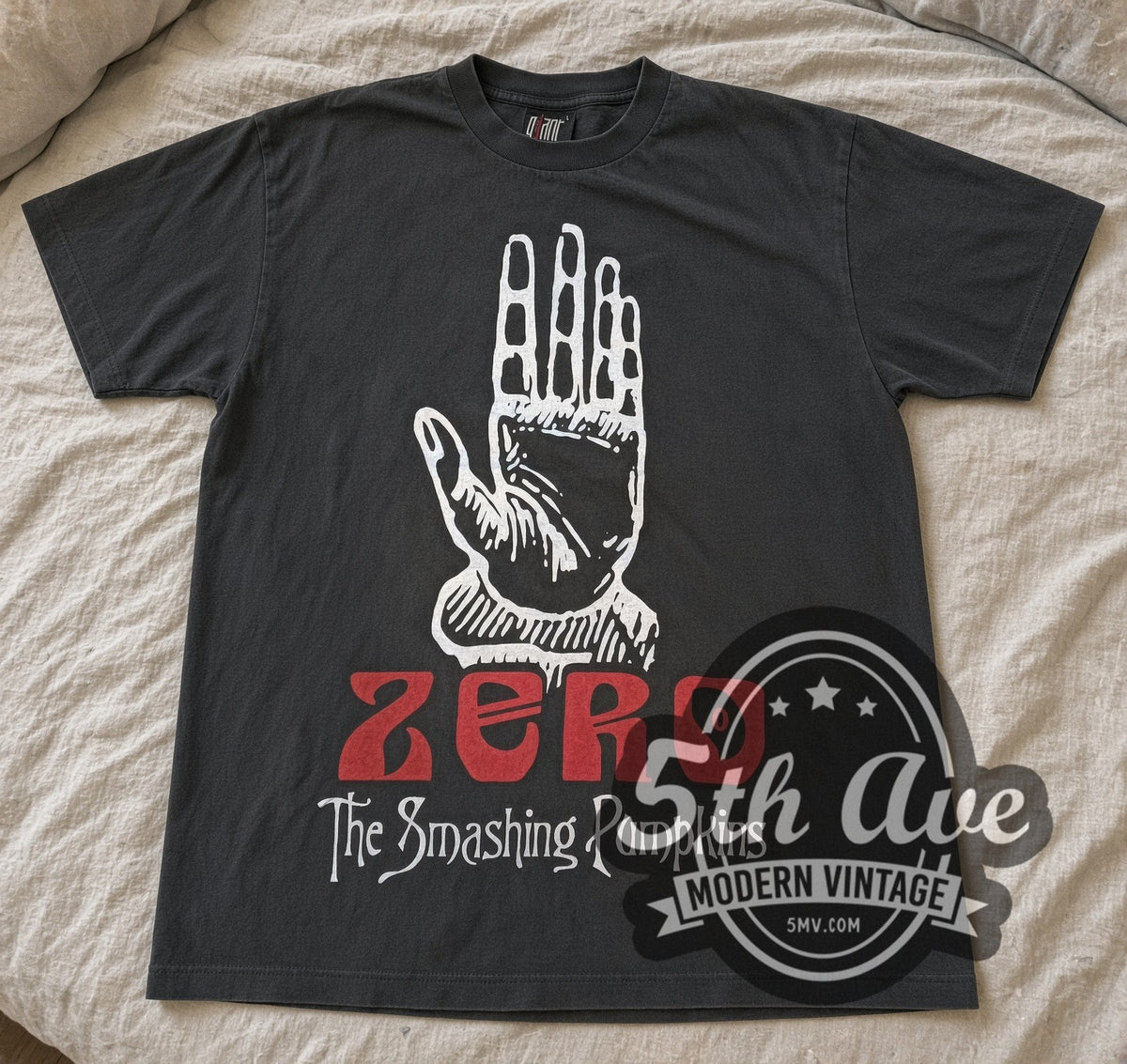 Faded black Smashing Pumpkins Zero hand tee laid flat on linen bed