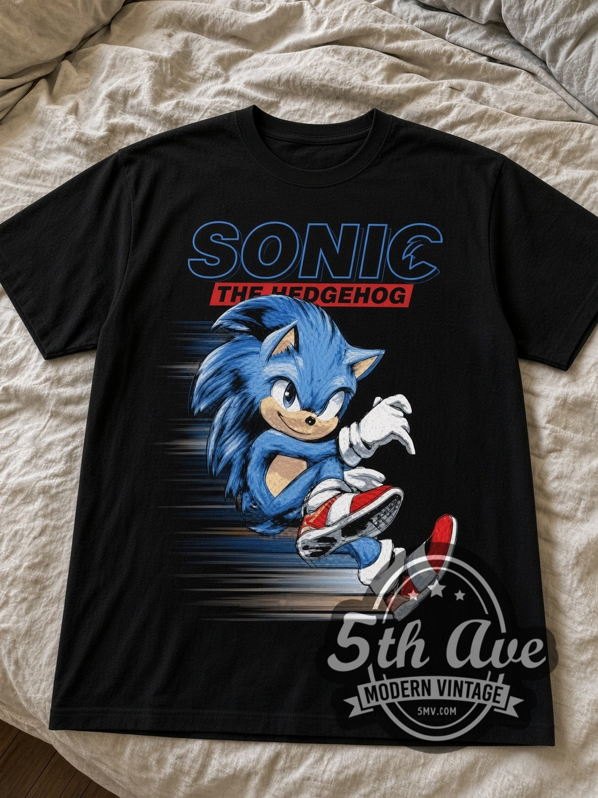 Sonic the Hedgehog running black graphic tee laid flat on linen bed