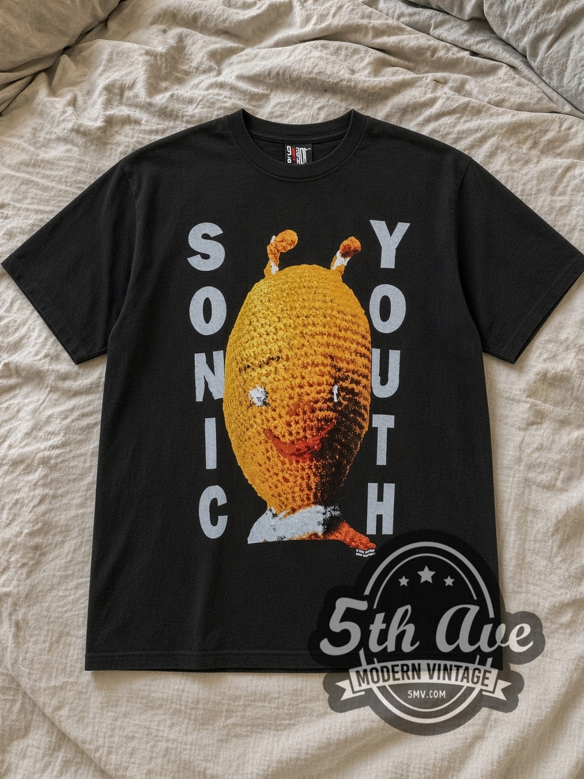 Black Sonic Youth Dirty Knitted Doll Vintage Band T-Shirt laid flat on a linen bed