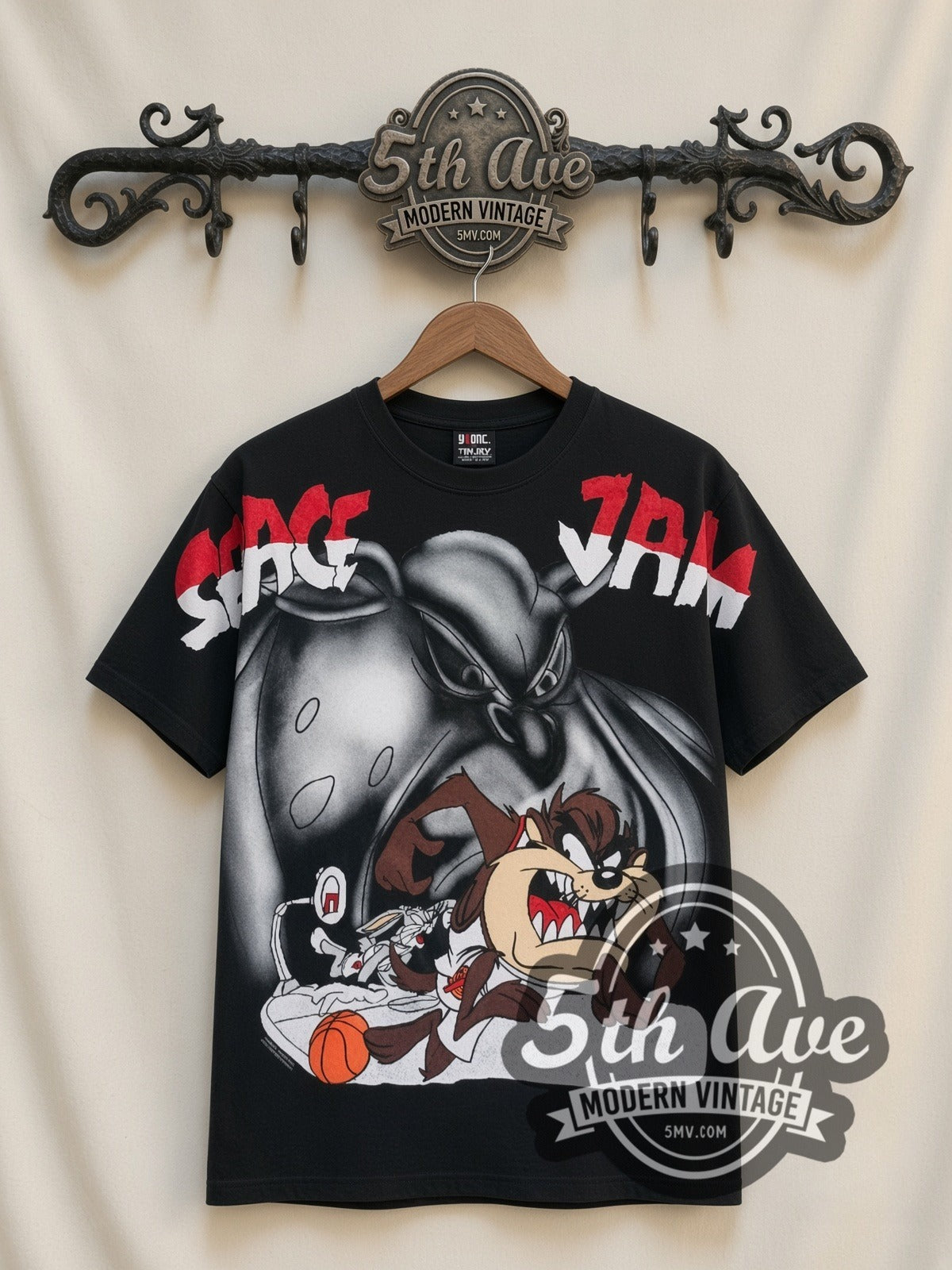Space Jam Taz & Monstar all-over-print vintage cartoon t-shirt in black, front view on a display rack