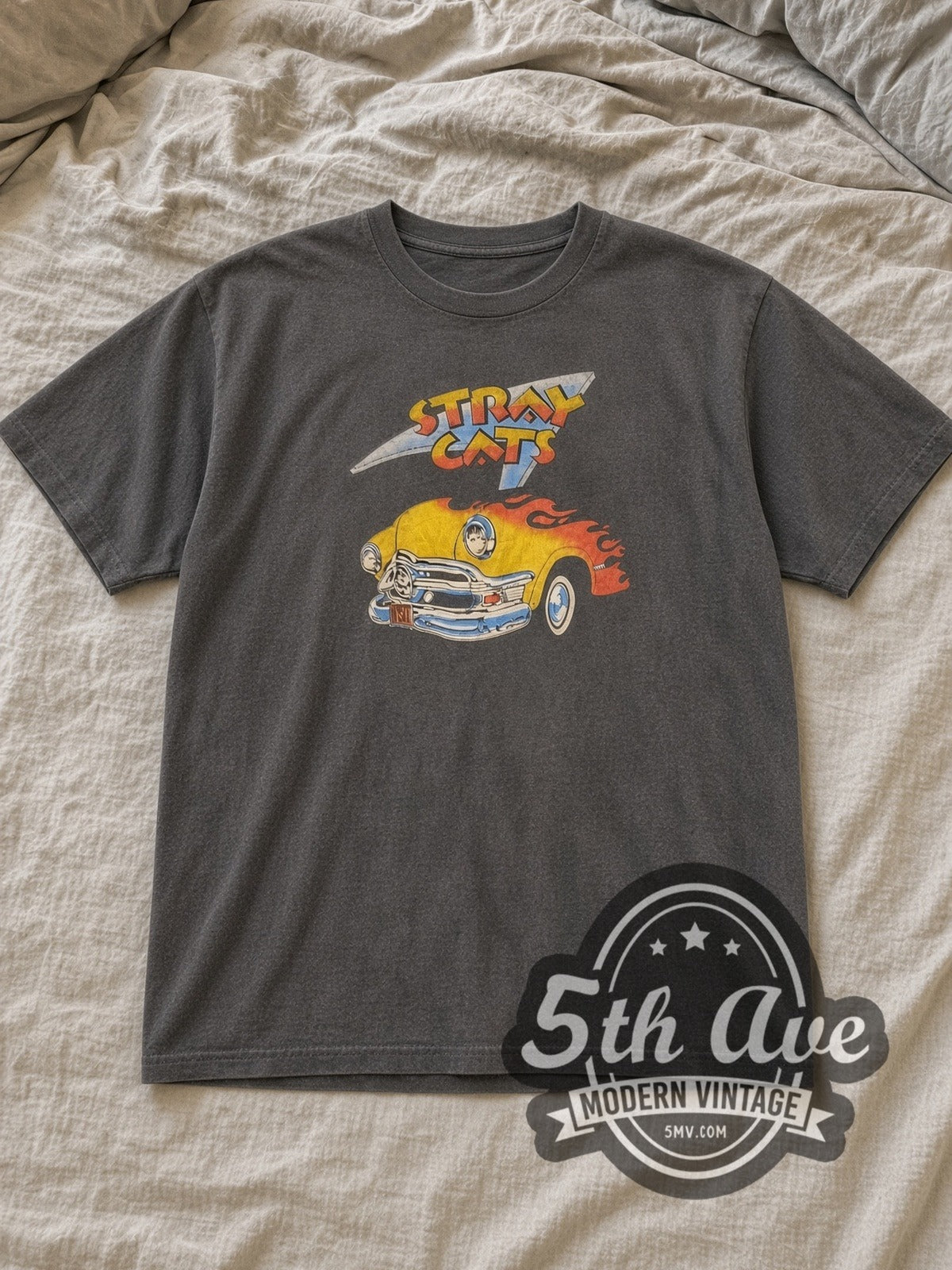 Charcoal Stray Cats Flaming Hot Rod Vintage Band T-Shirt laid flat on a linen bed