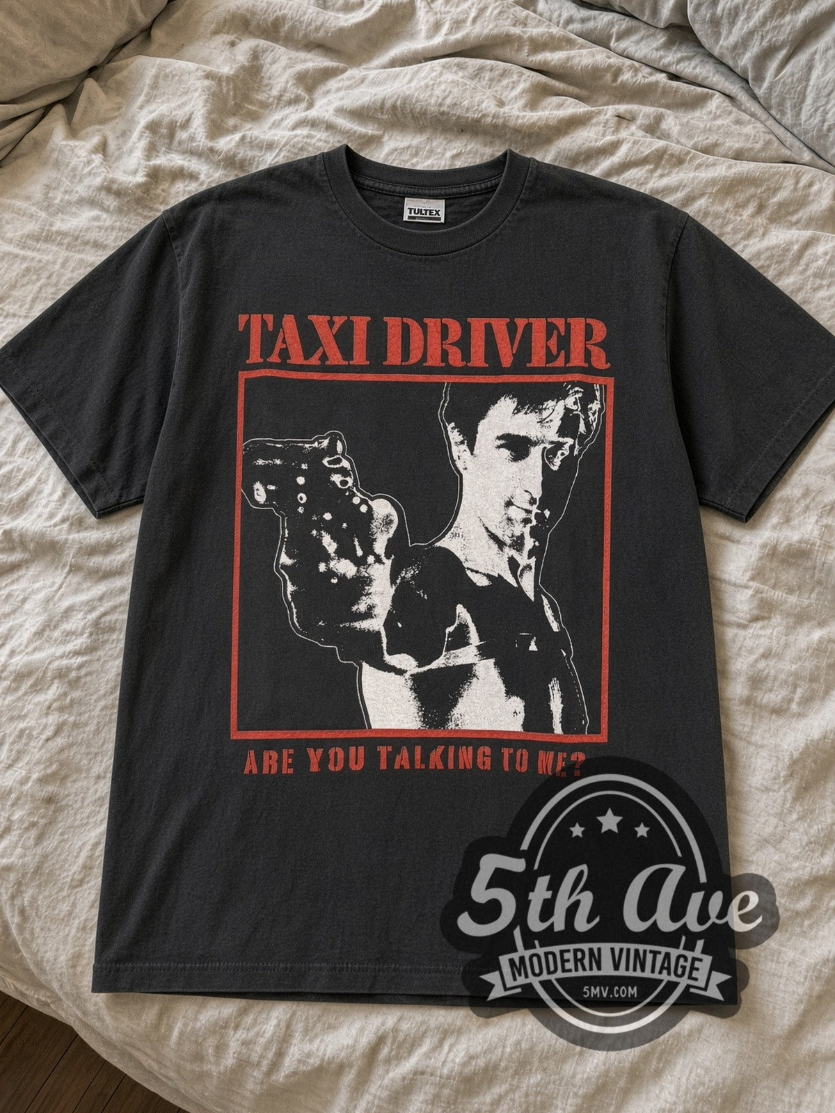 Black Taxi Driver Are You Talking to Me tee laid flat on linen bed