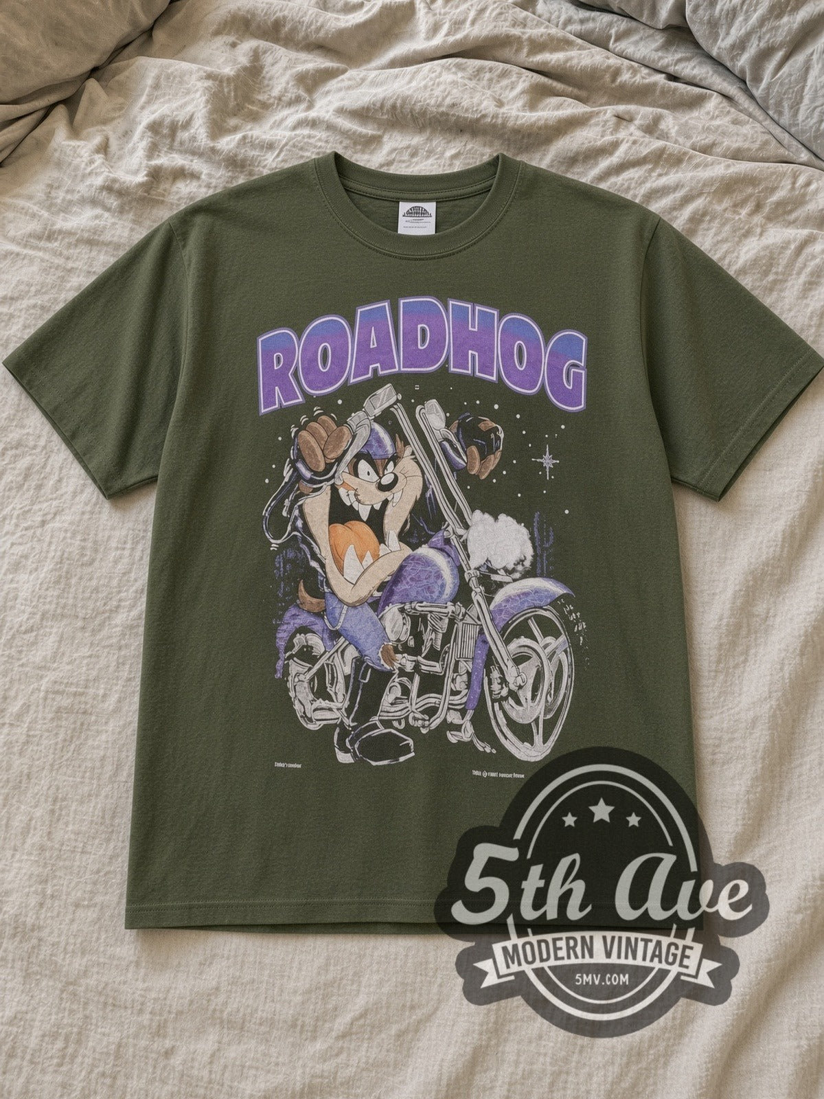 Olive Taz Roadhog Harley Davidson Vintage Harley-Davidson T-Shirt laid flat on a linen bed