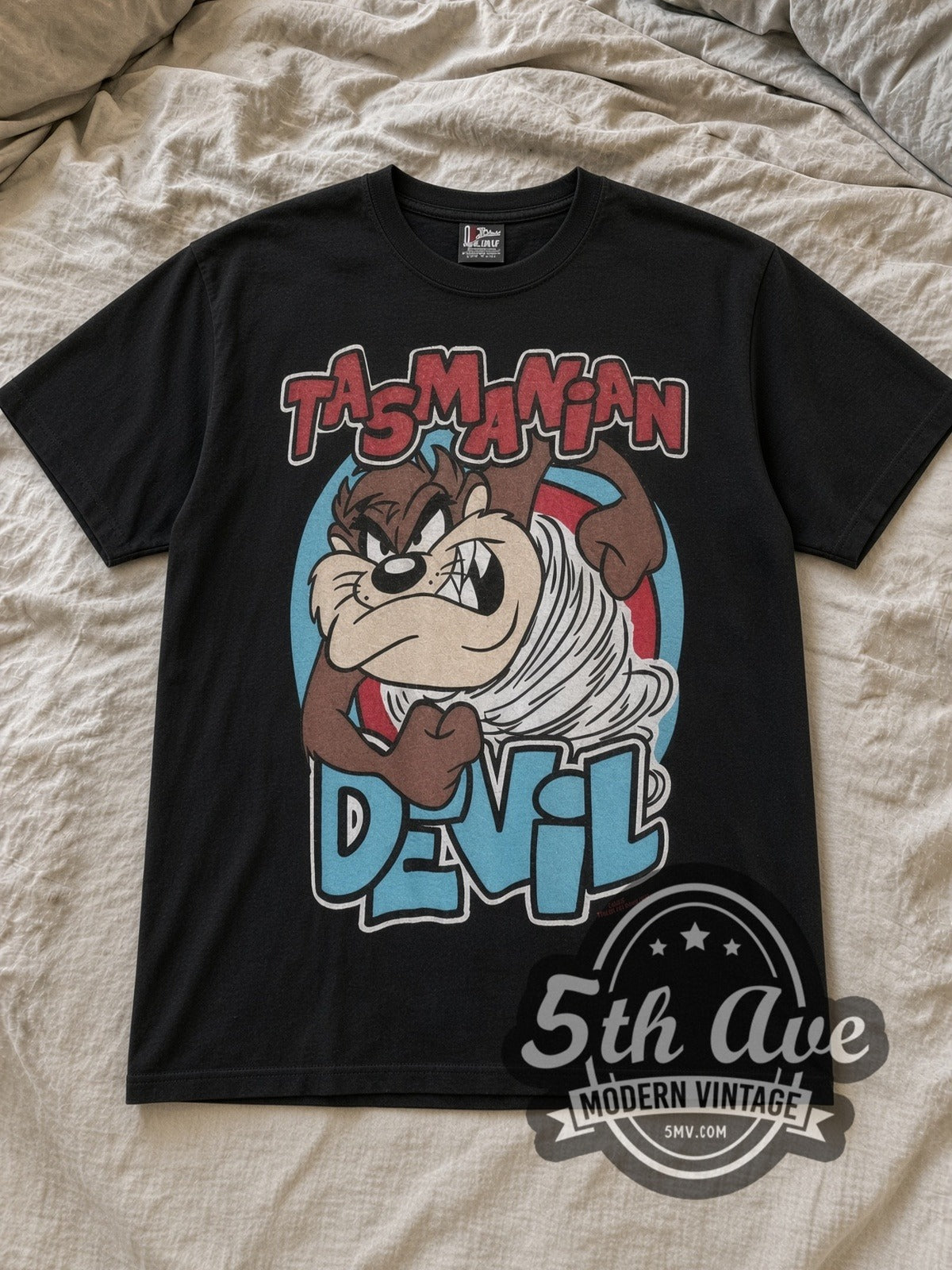 Black Taz's Gym No Pencilnecks Black Vintage Cartoon T-Shirt laid flat on a linen bed