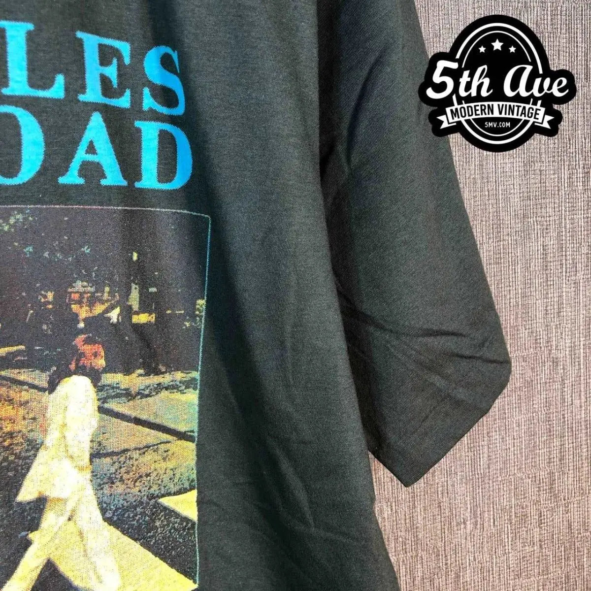 Model wearing The Beatles – Abbey Road Crossing Cyan Logo vintage band tee
