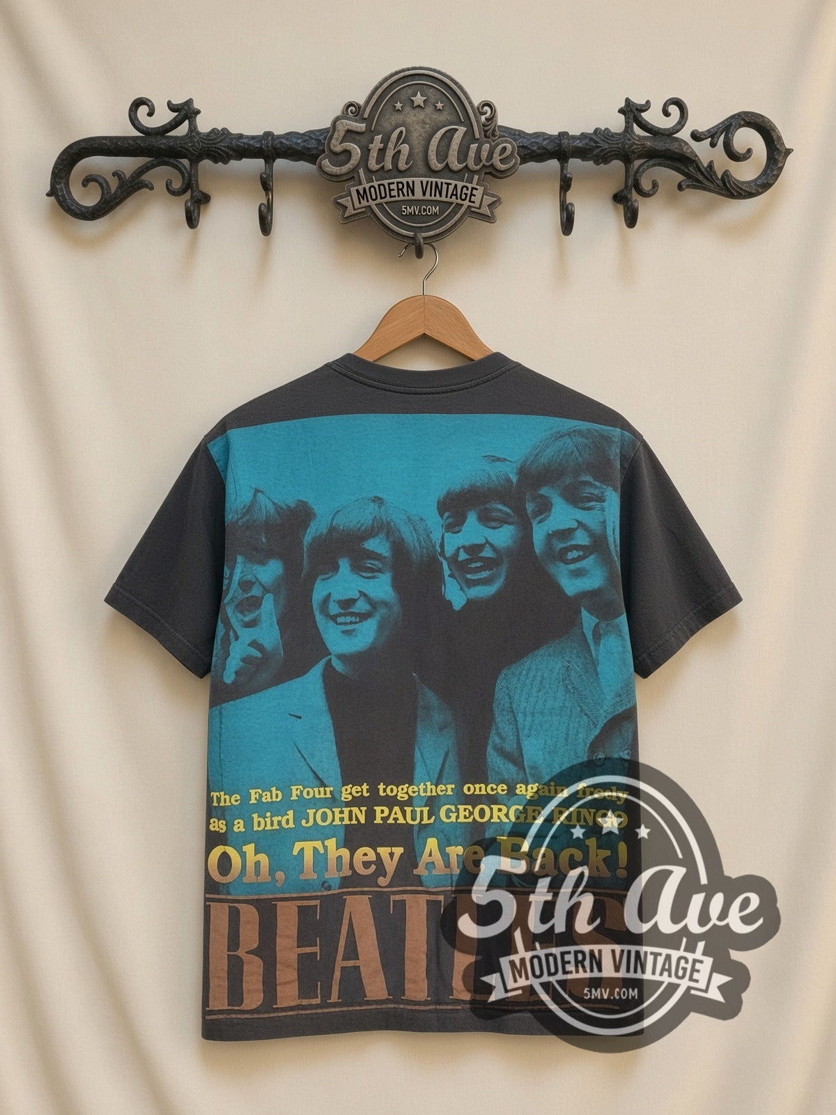 The Beatles Fab Four Collage all-over-print vintage band t-shirt, back view on a display rack