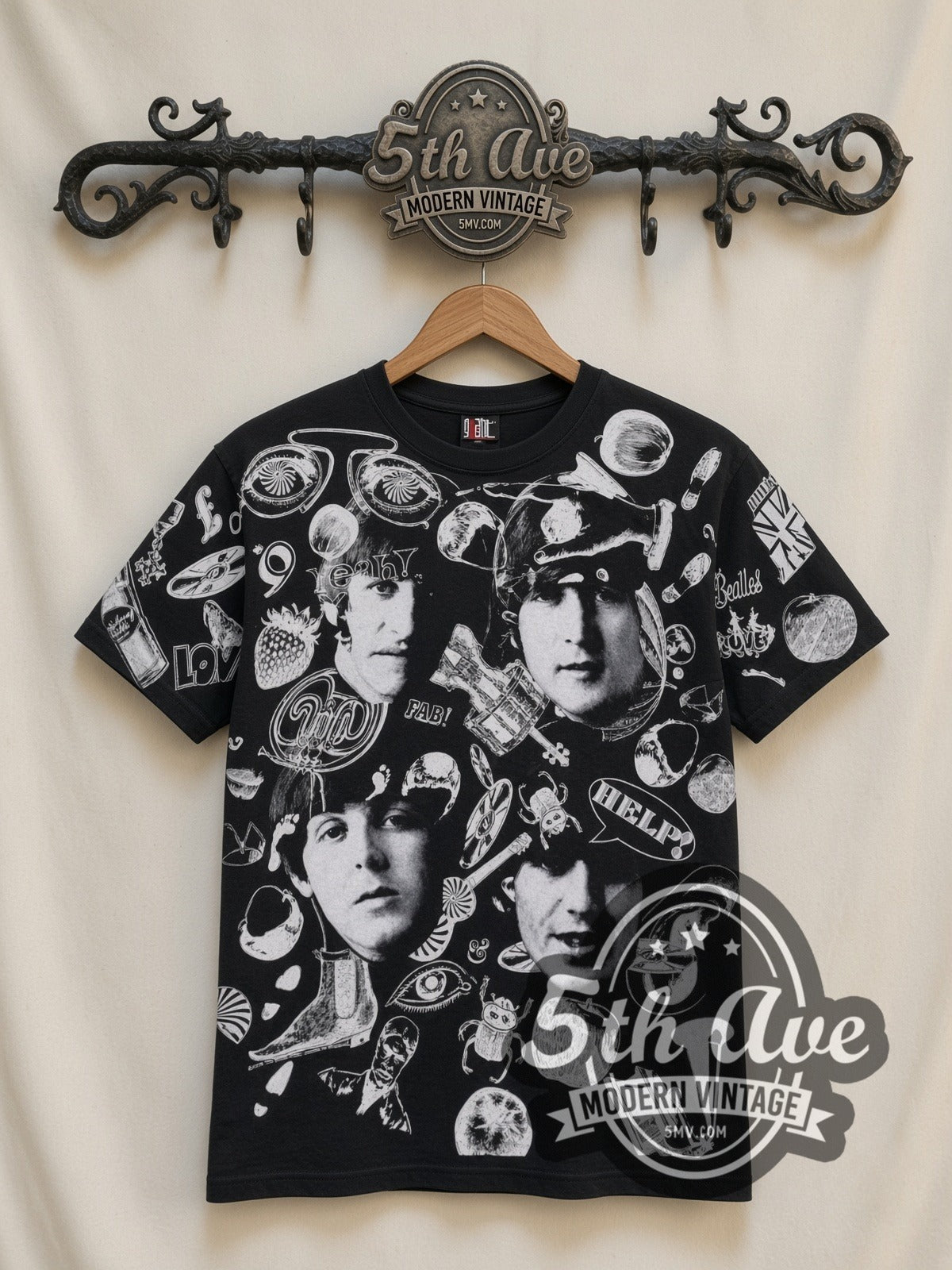 The Beatles Help Collage all-over-print vintage band t-shirt in black, front view on a display rack
