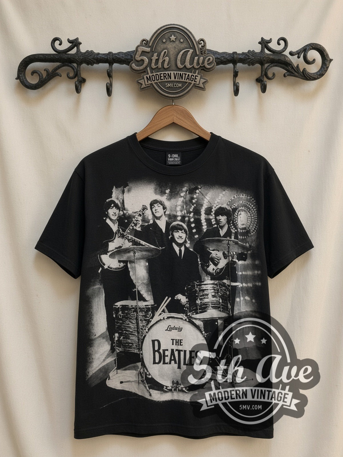 The Beatles Live Abbey Drums all-over-print vintage band t-shirt, front view on a display rack