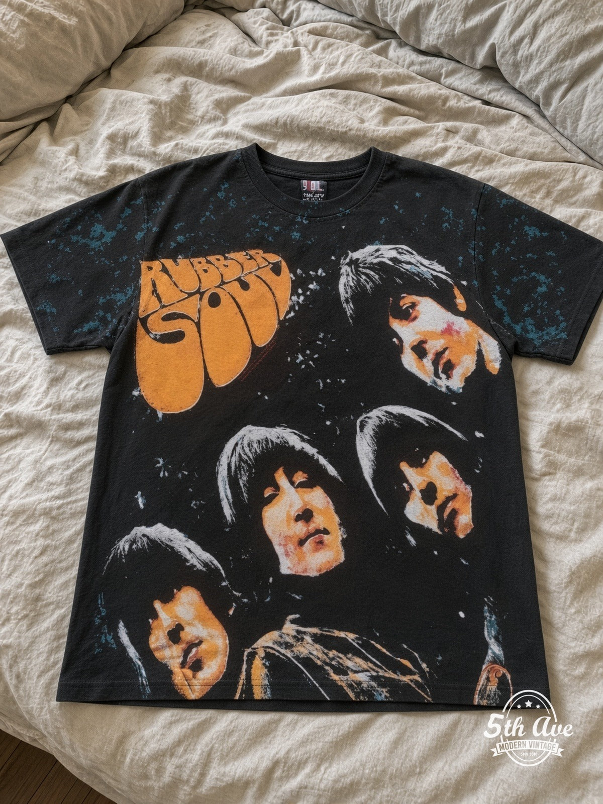 The Beatles Rubber Soul Black all over print vintage tee laid on bed