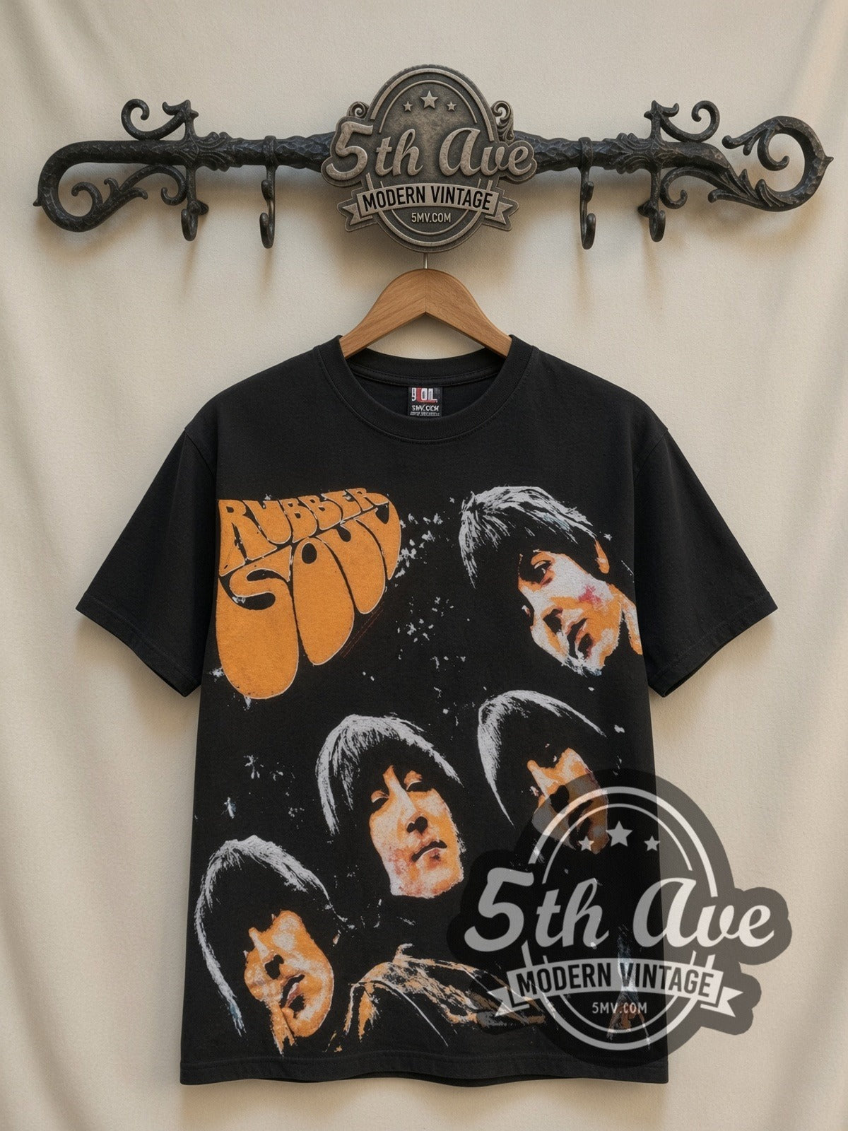 The Beatles Rubber Soul all-over-print vintage band t-shirt in black, front view on a display rack