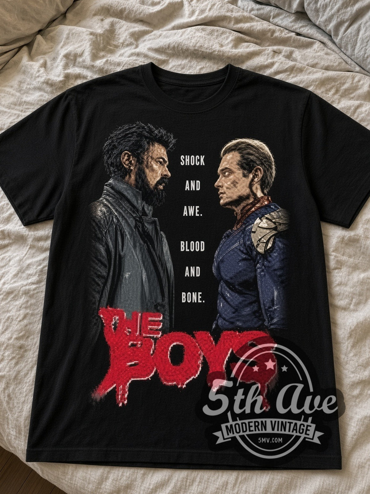 The Boys Butcher vs Homelander black graphic tee laid flat on linen bed