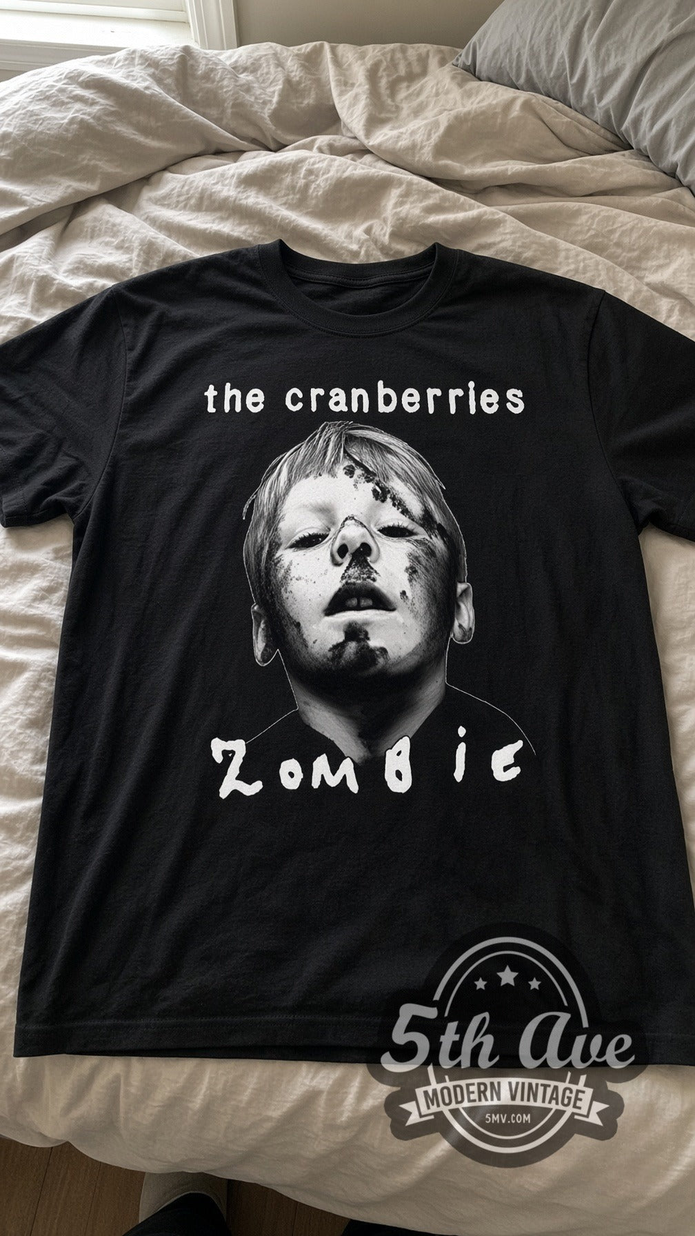 The Cranberries Zombie vintage band t-shirt in black laid flat on a bed, front artwork