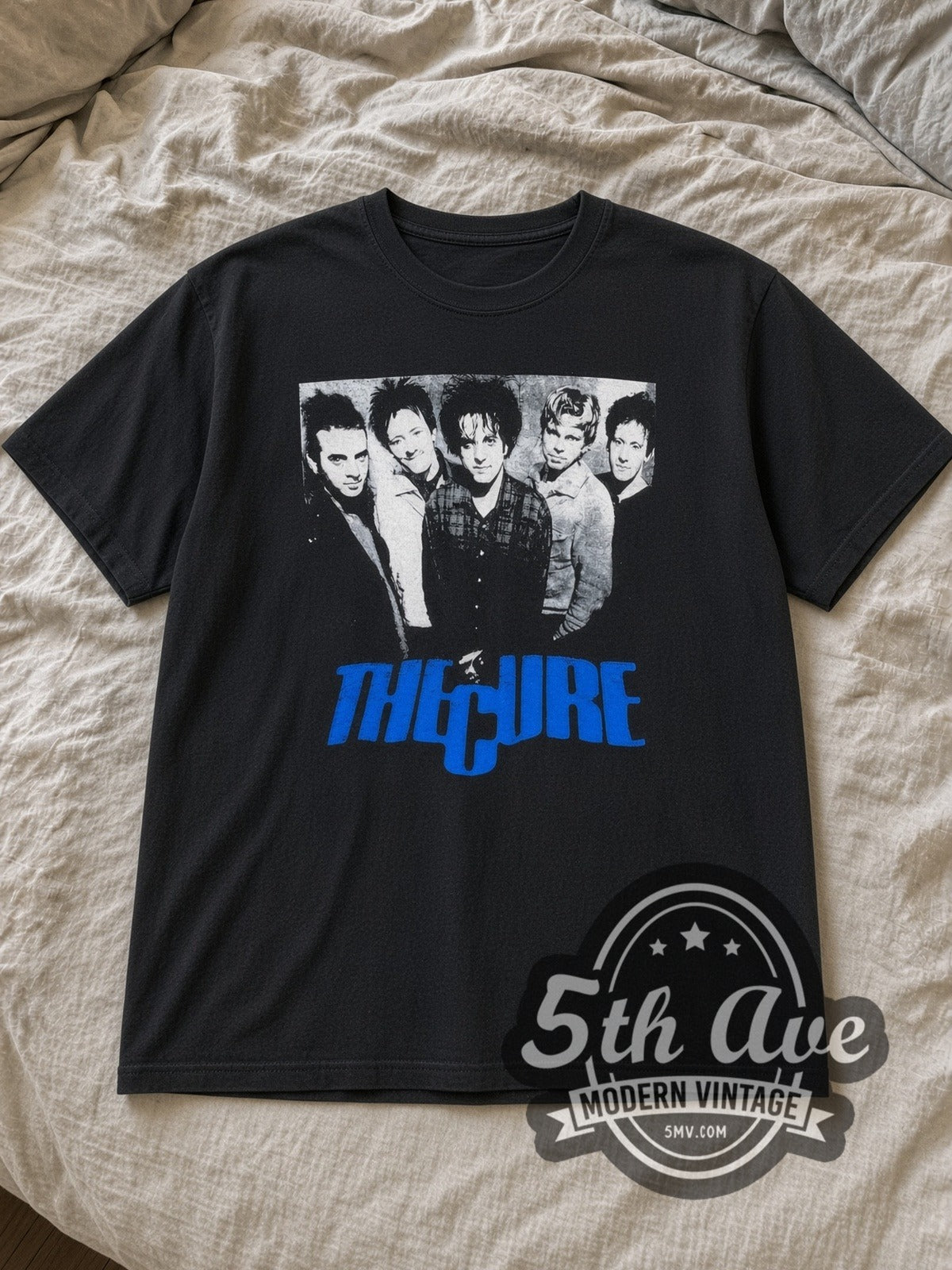 Black The Cure Five Member Photo Blue Logo Vintage Band T-Shirt laid flat on a linen bed