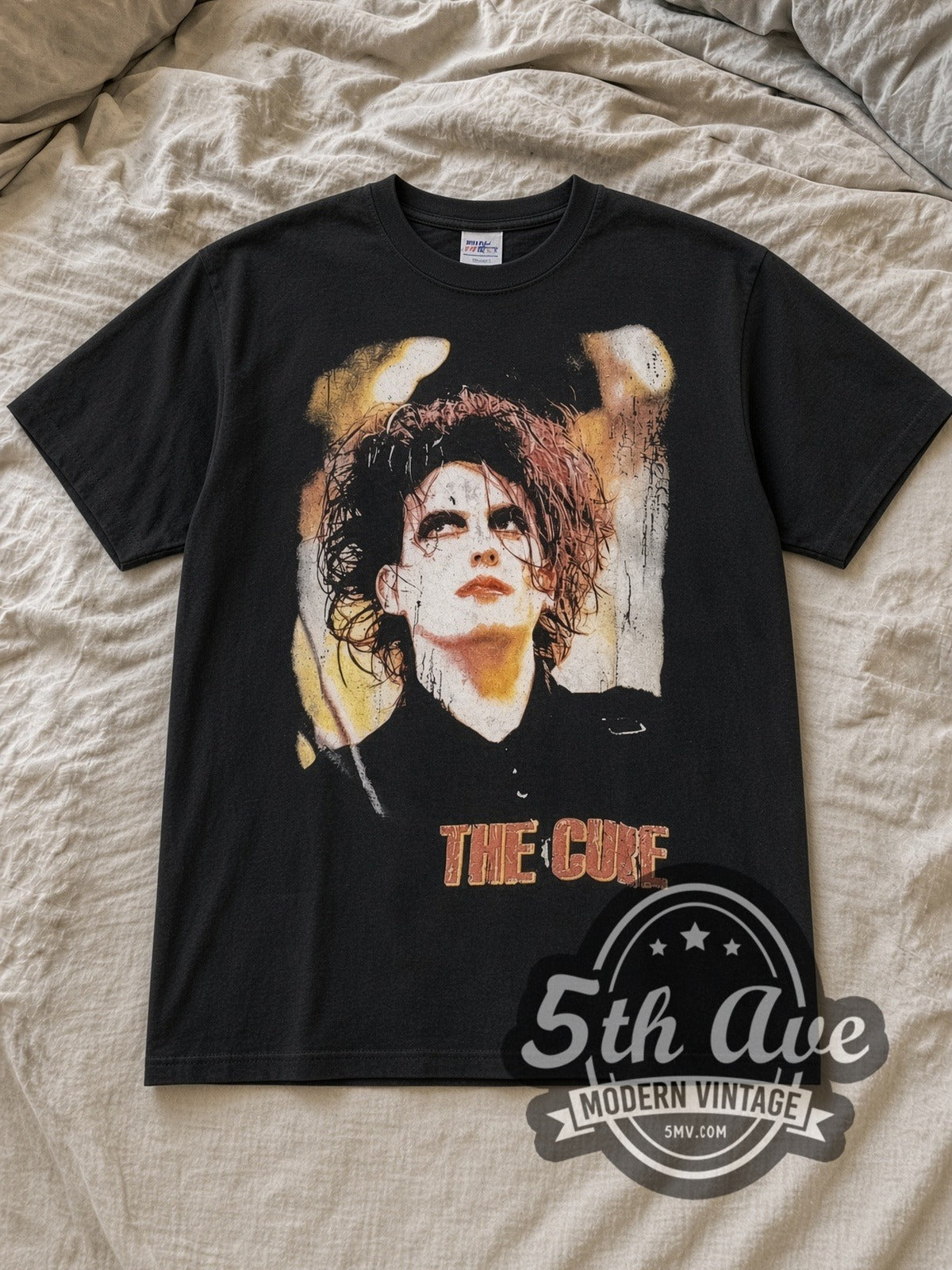 Black The Cure Greatest Hits Vintage Band T-Shirt laid flat on a linen bed