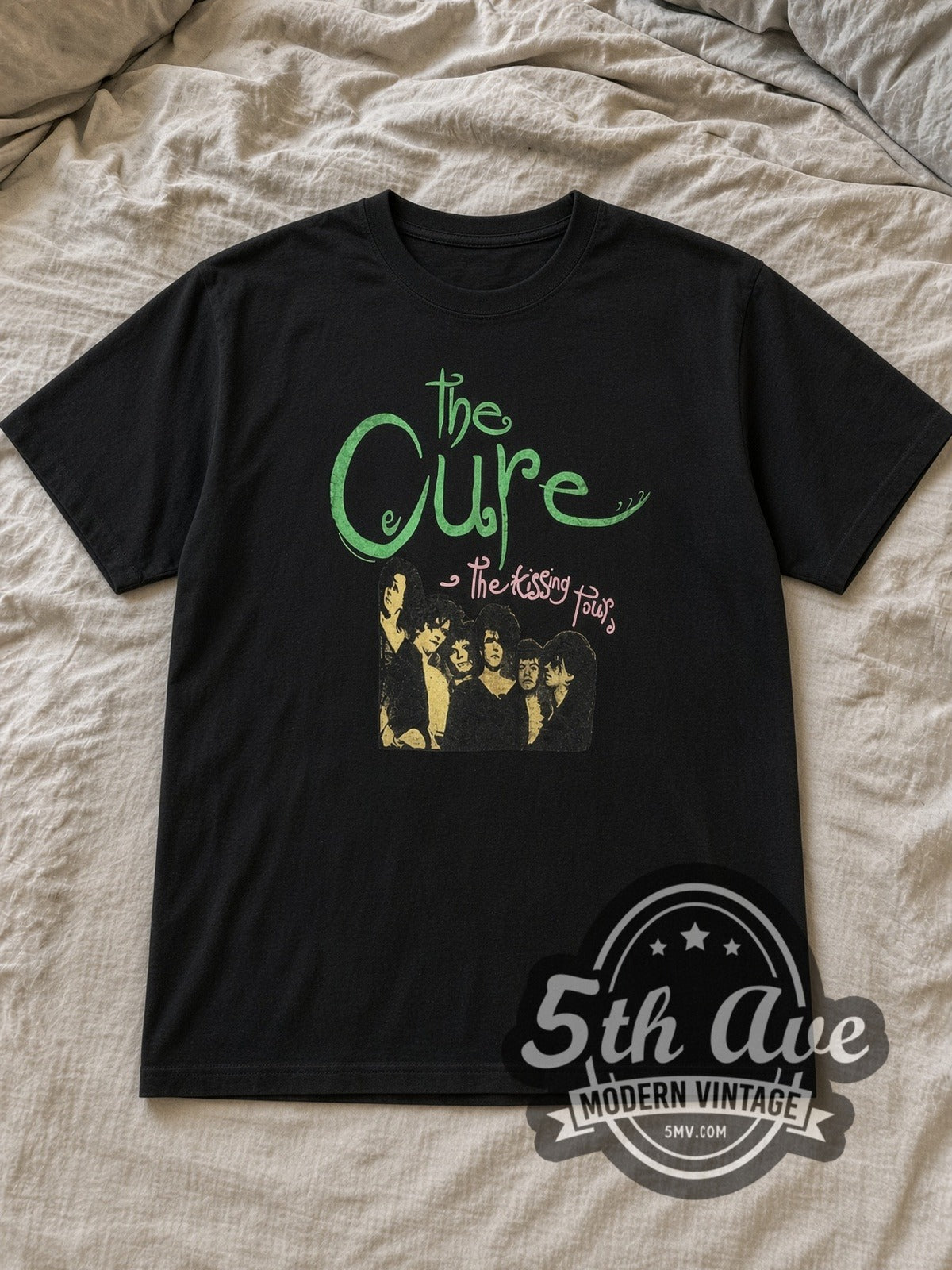 Black The Cure The Kissing Tour Vintage Band T-Shirt laid flat on a linen bed
