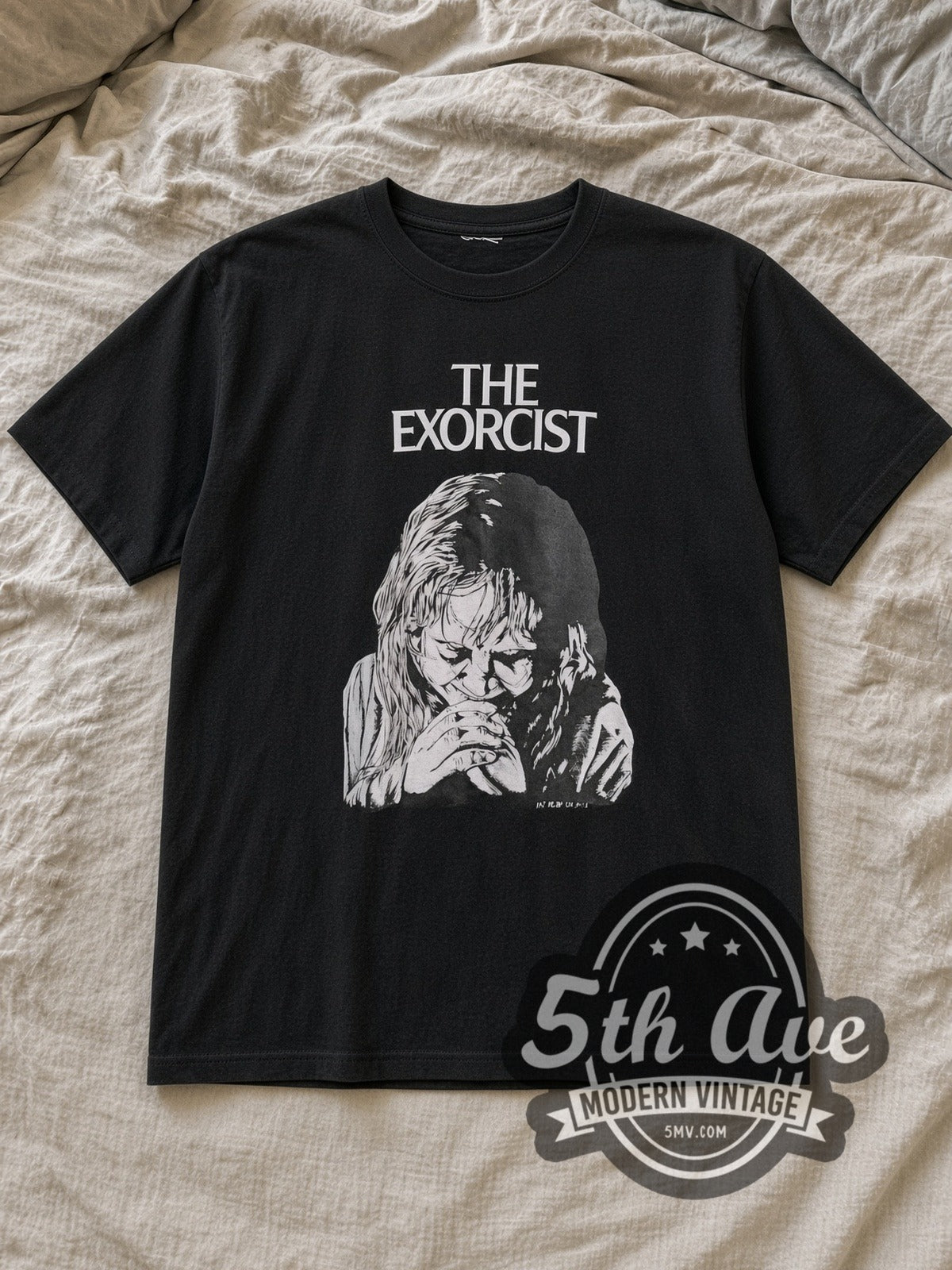 Black The Exorcist Vintage Movie T-Shirt laid flat on a linen bed