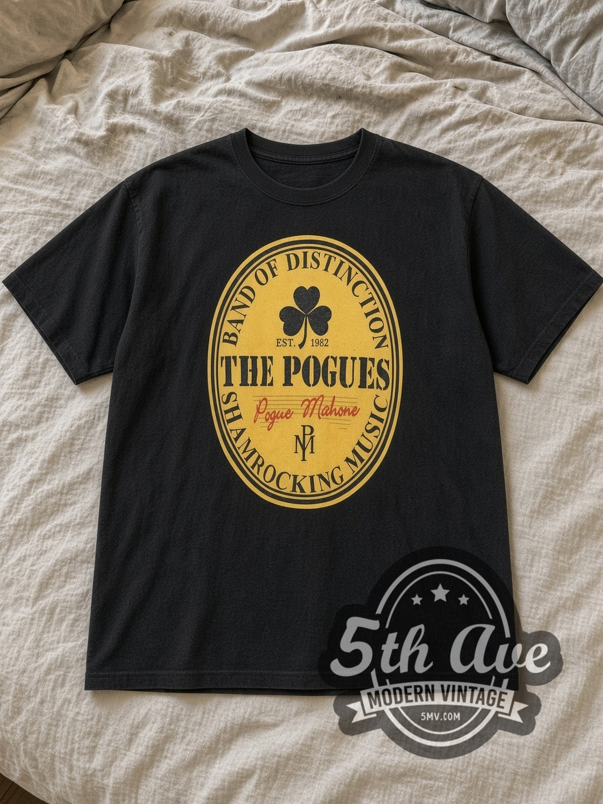Black The Pogues Pogue Mahone Vintage Band T-Shirt laid flat on a linen bed